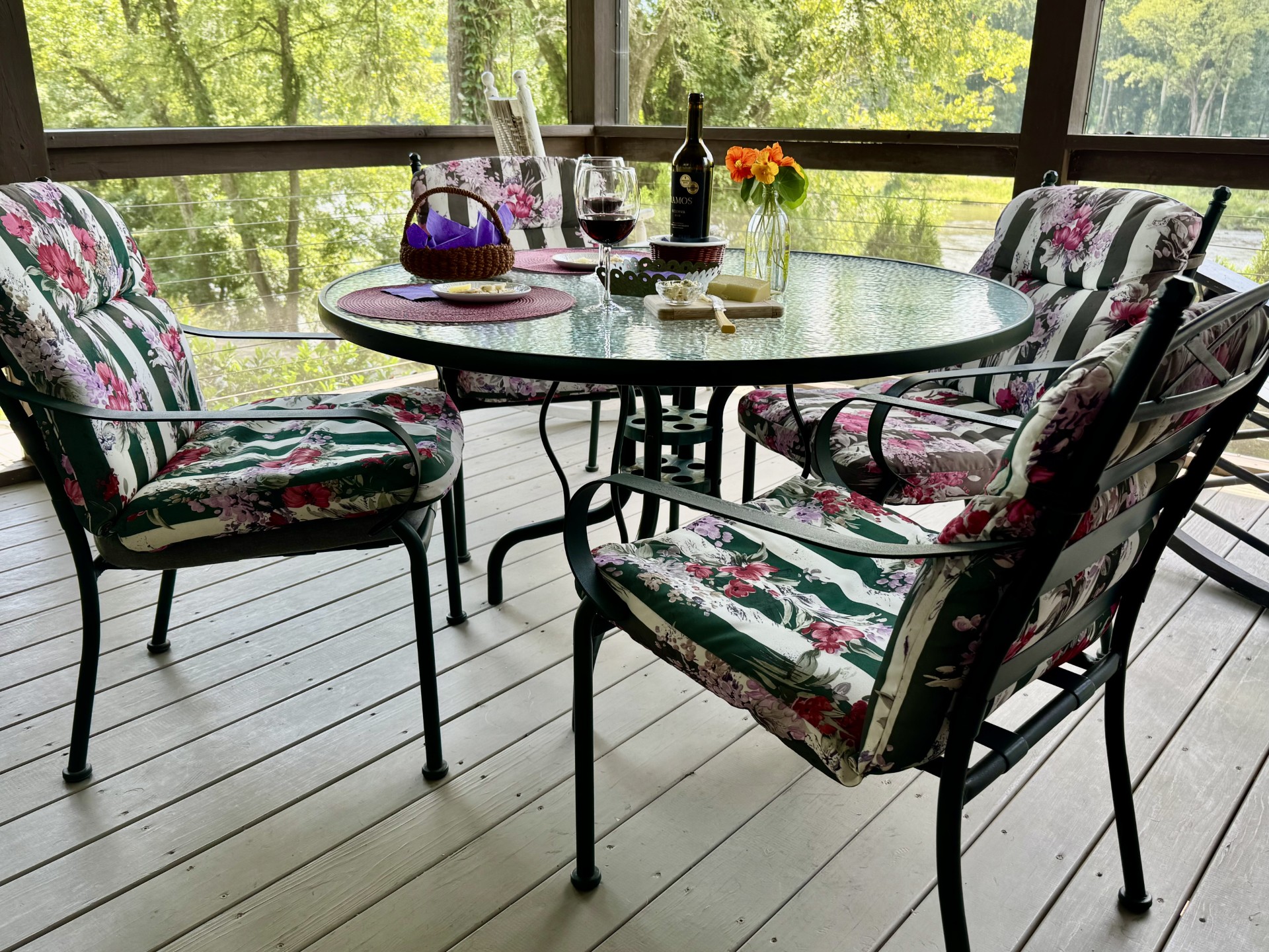 Screened-in dining porch with scenic river views