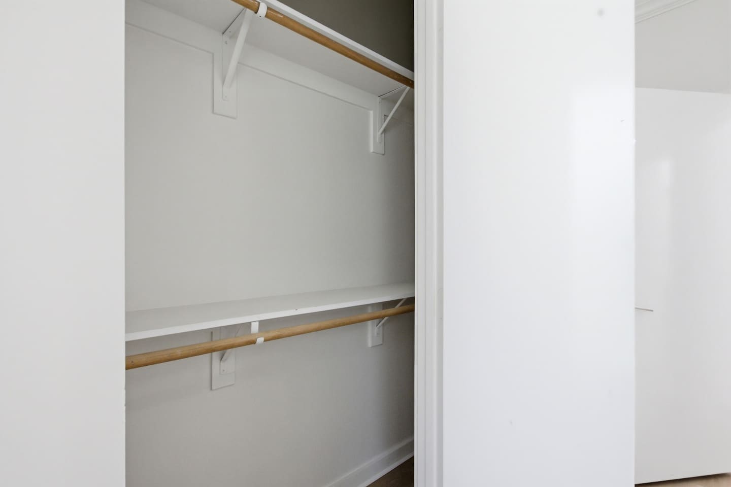 First-floor bedroom closet with open shelving and hanging space. Easy to access and organized for guests on the lower level who want their own dedicated storage area.


