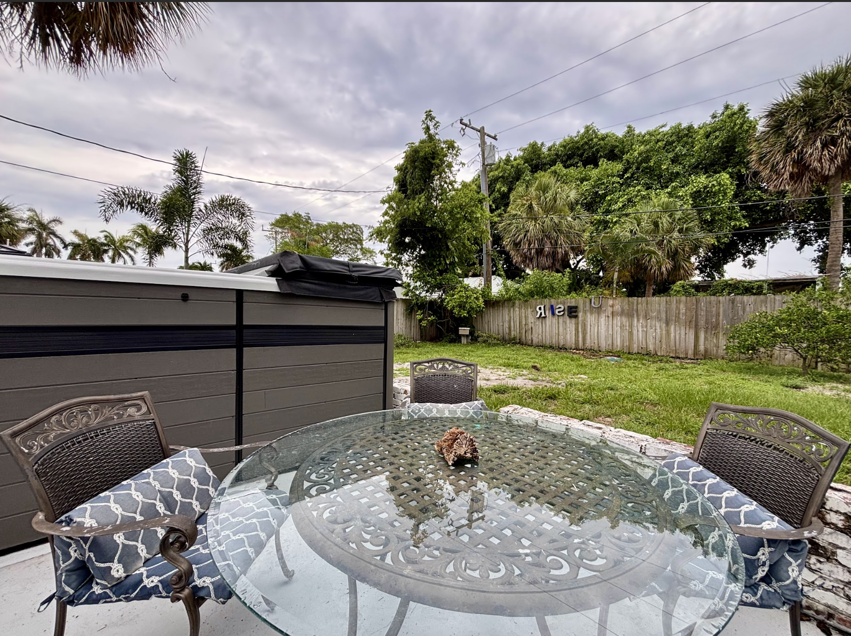 Enjoy the patio as you take in the tropical scenery next to the swim spa.