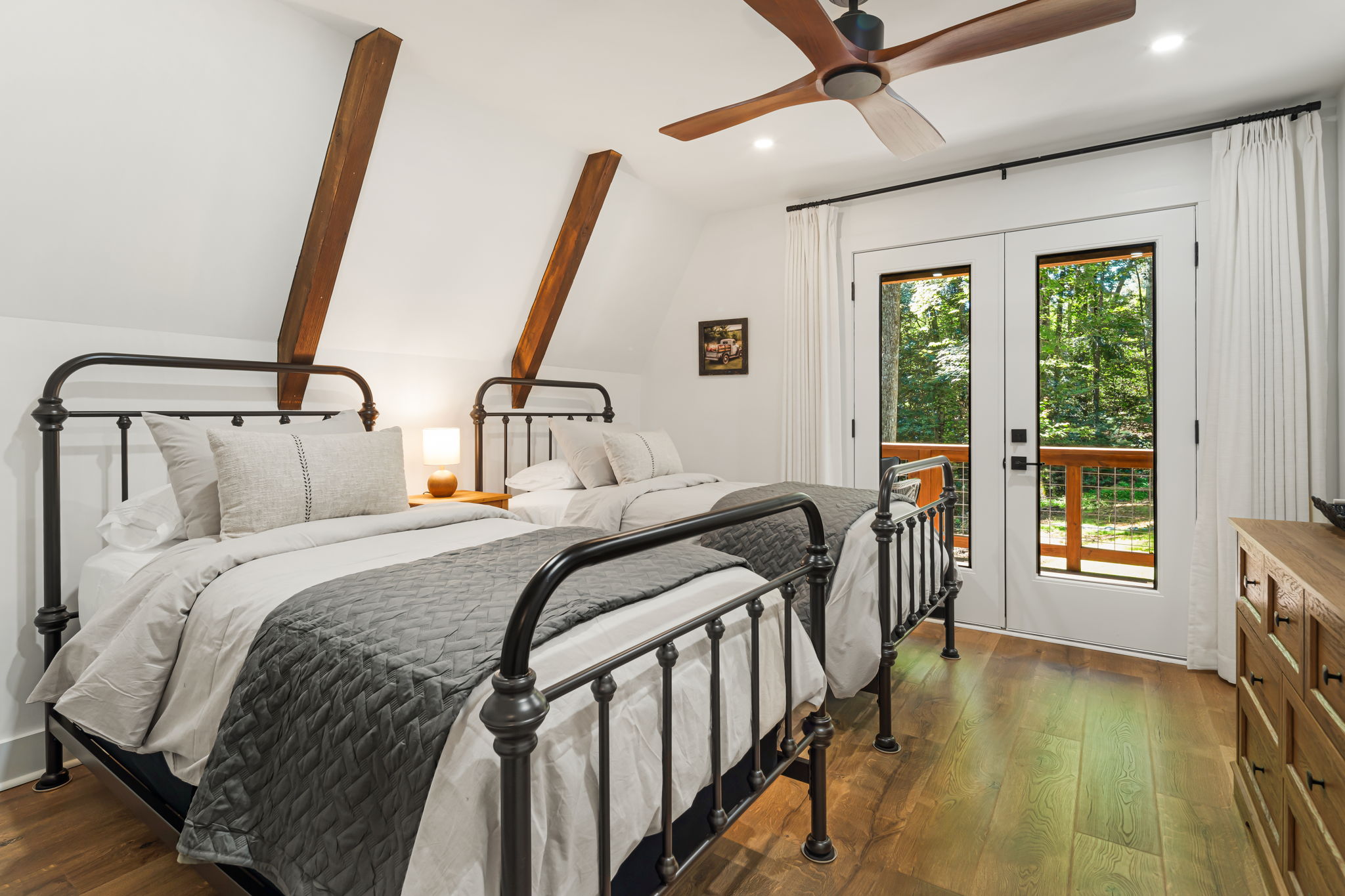 This bedroom on the main floor offers 2 twin beds and its outfitted with a dresser and a walk-in closet with hangers and open shelving for storage. Luggage racks and additional blankets are also available for extra convenience.  