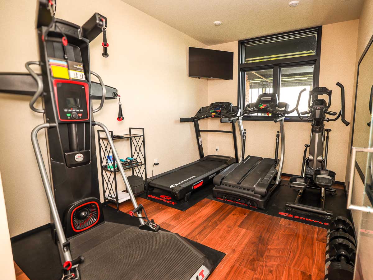 Fitness room at Sunset Falls &mdash; treadmill, elliptical, cable trainer, free weights