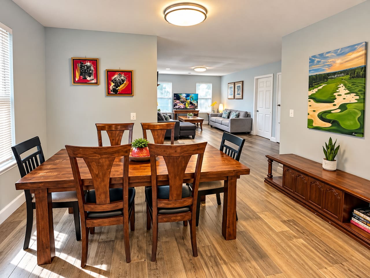 Dining Room: Enjoy meals with style at this spacious wood table, bathed in natural light!