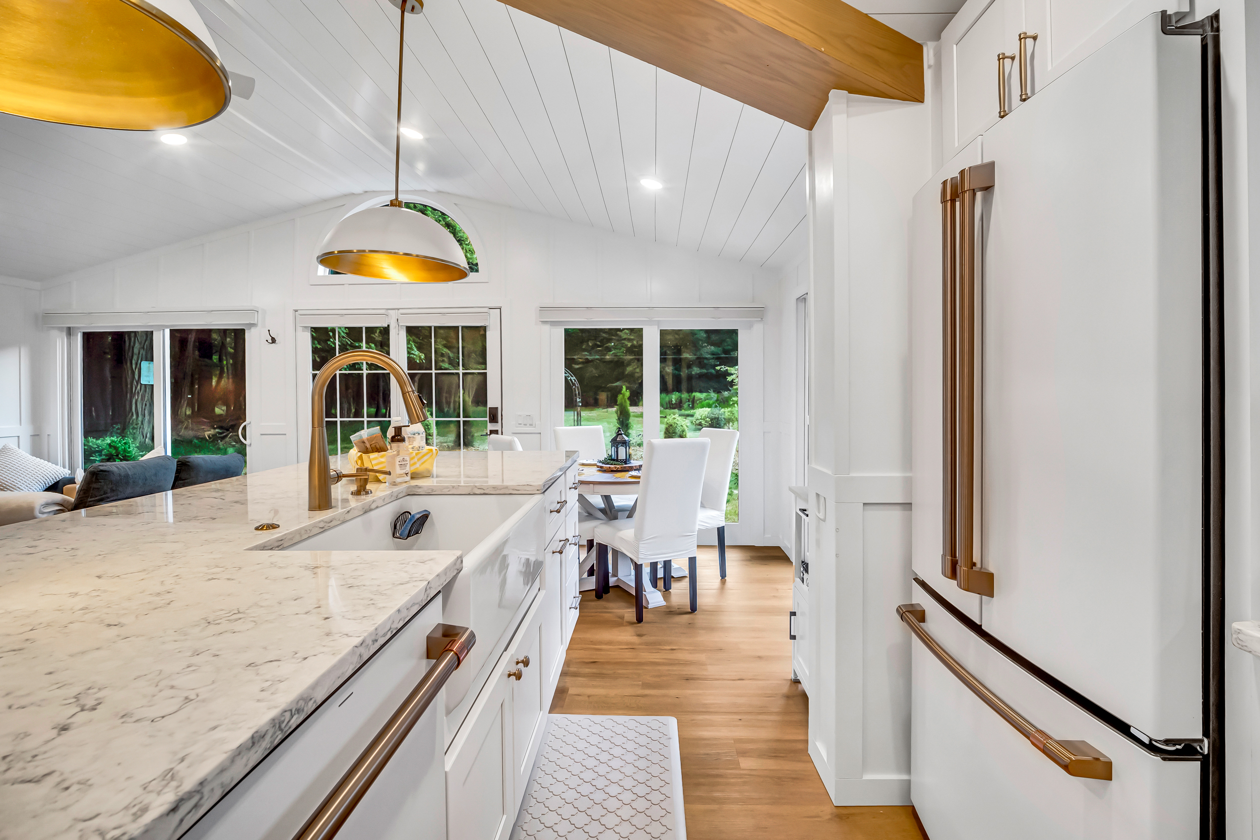 Large modern kitchen includes island counter with deep farmhouse sink