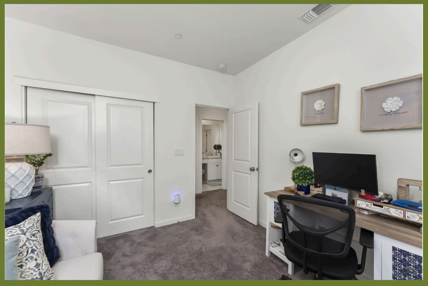 Office with desk workspace, TV, closet storage, and a twin sleeper chair that converts into an extra bed.