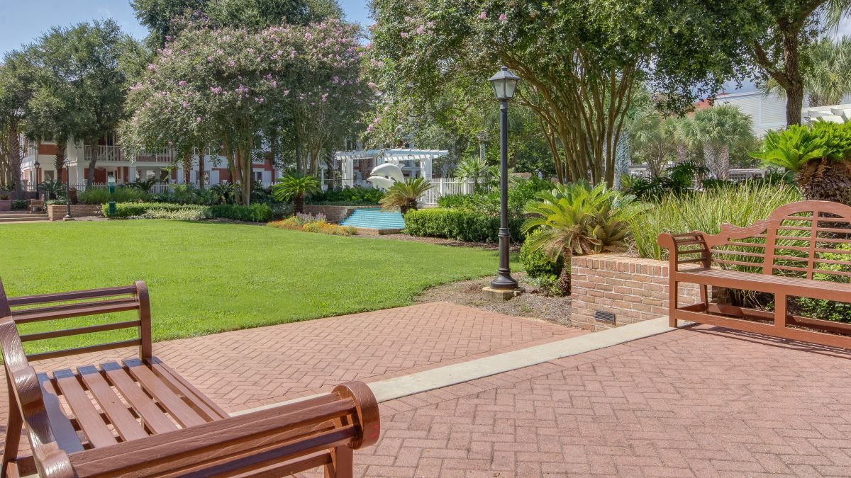 Resort lawn, benches and dolphin fountain near Baytowne Wharf