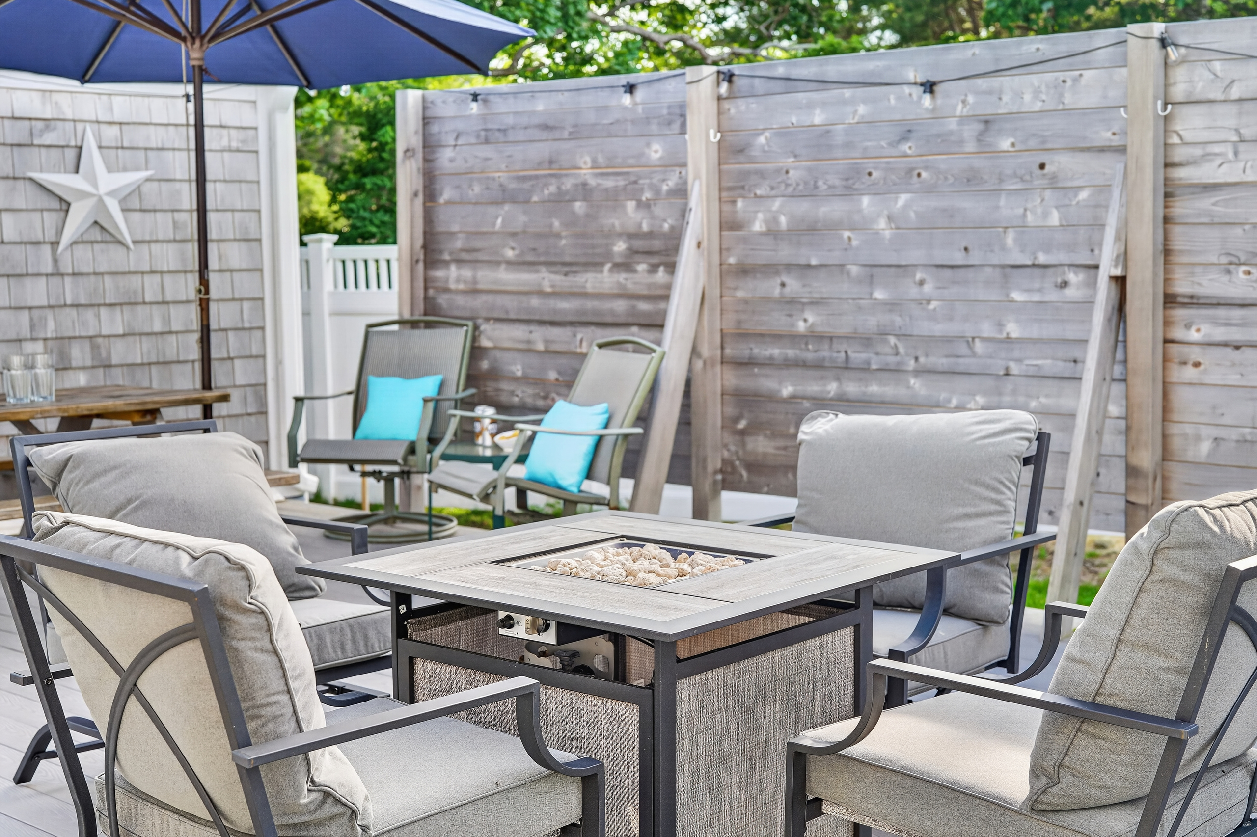 Cozy fire table surrounded by comfortable seating—perfect for relaxing after a day at the beach.