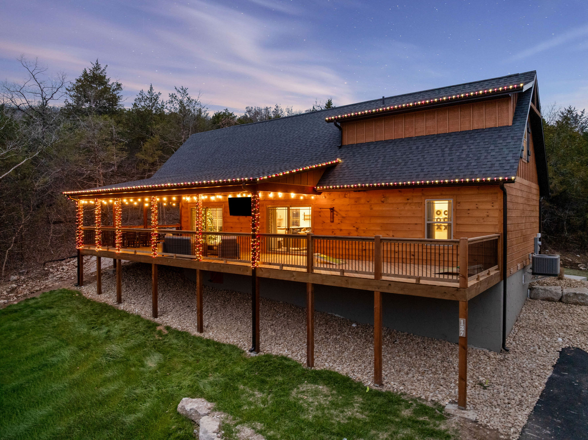 Evening glow highlights the cabin’s large deck and outdoor space.
