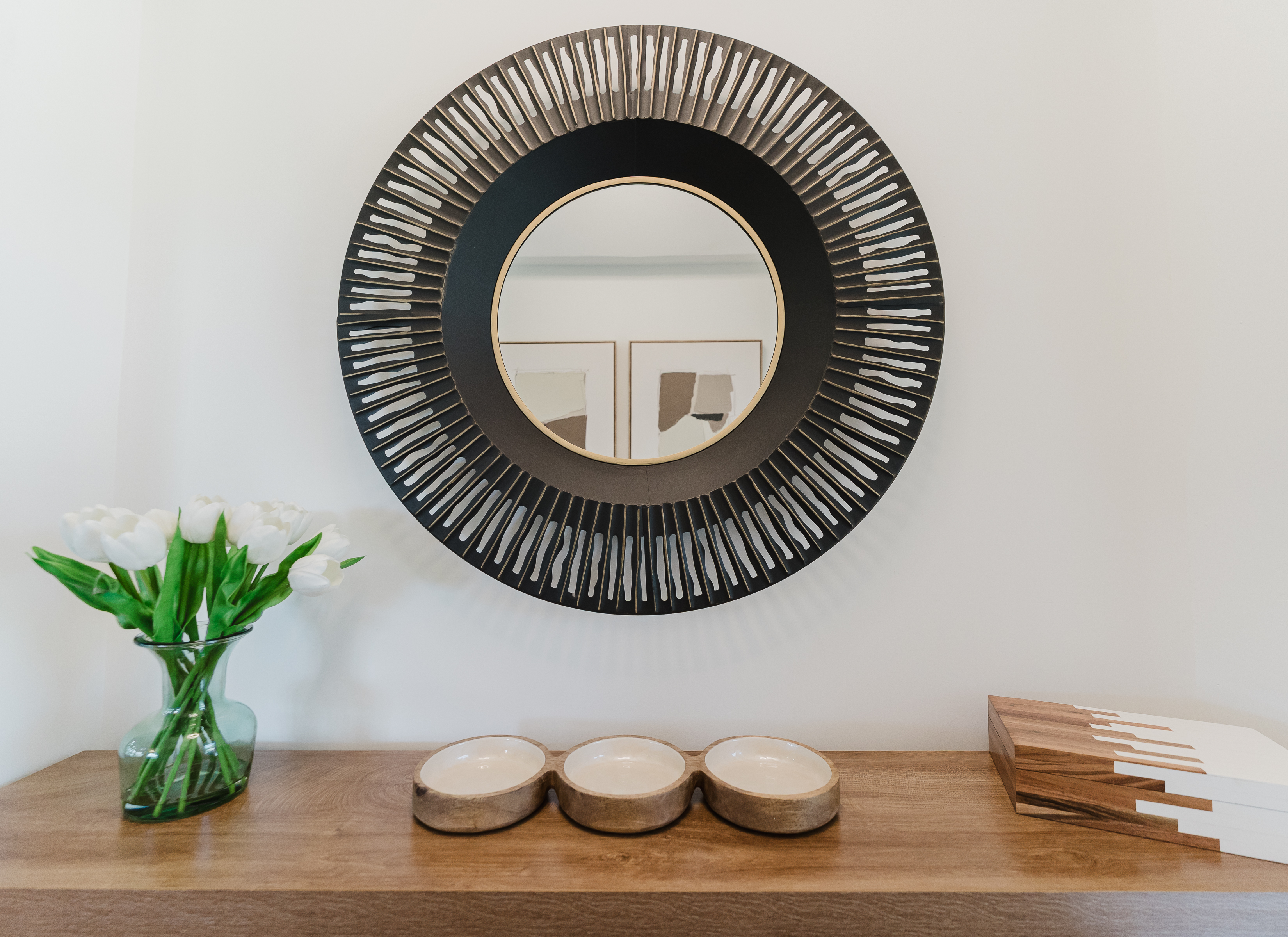 Stylish entry console with designer accents and a statement mirror, setting a warm and inviting first impression