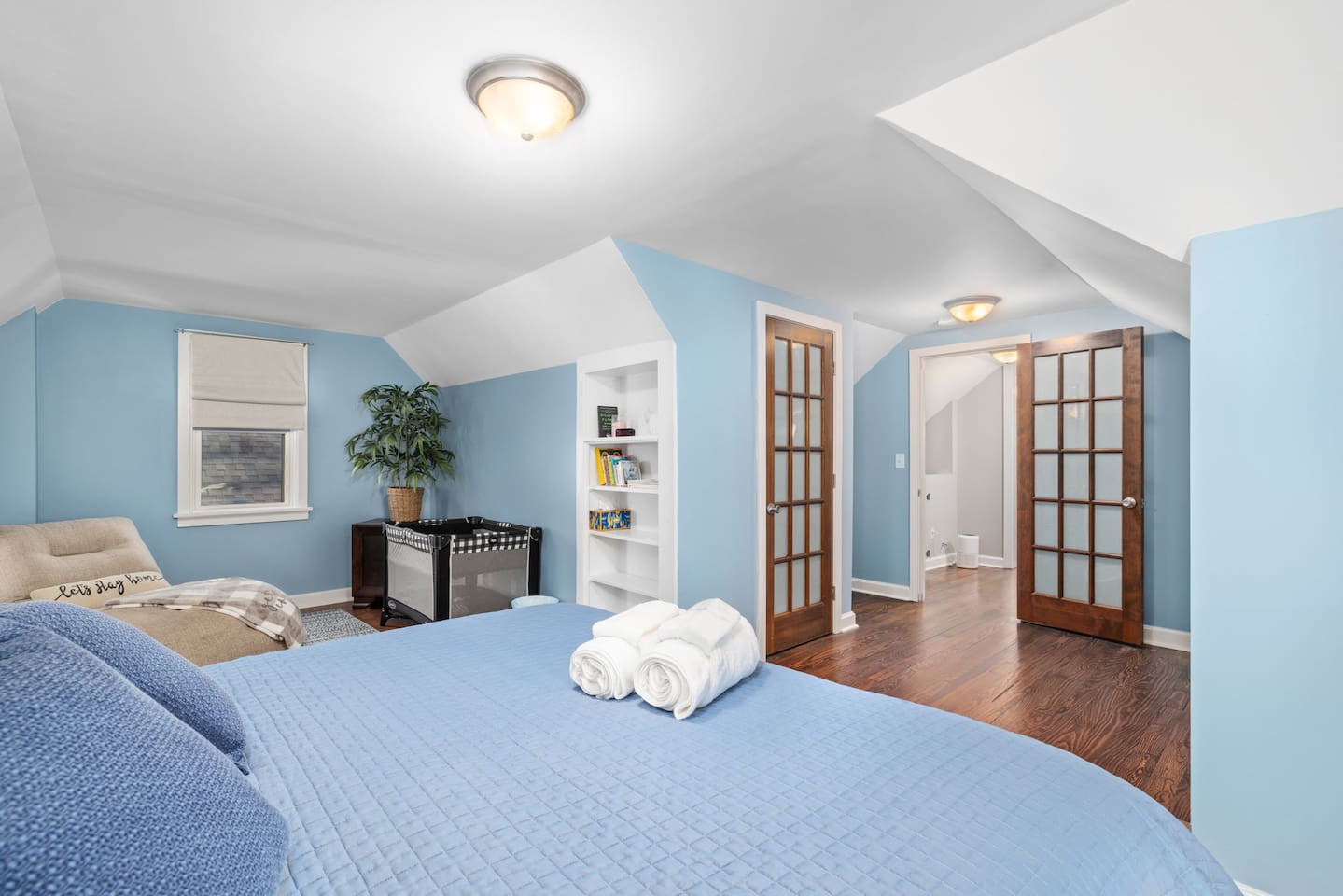 Upstairs bedroom 4 has cozy space for baby including Pack-n-Play with bassinet, board books for bedtime stories, and lounge area for mom or dad during naptime.  There is a retractable baby gate at top of stairs in the hall.
