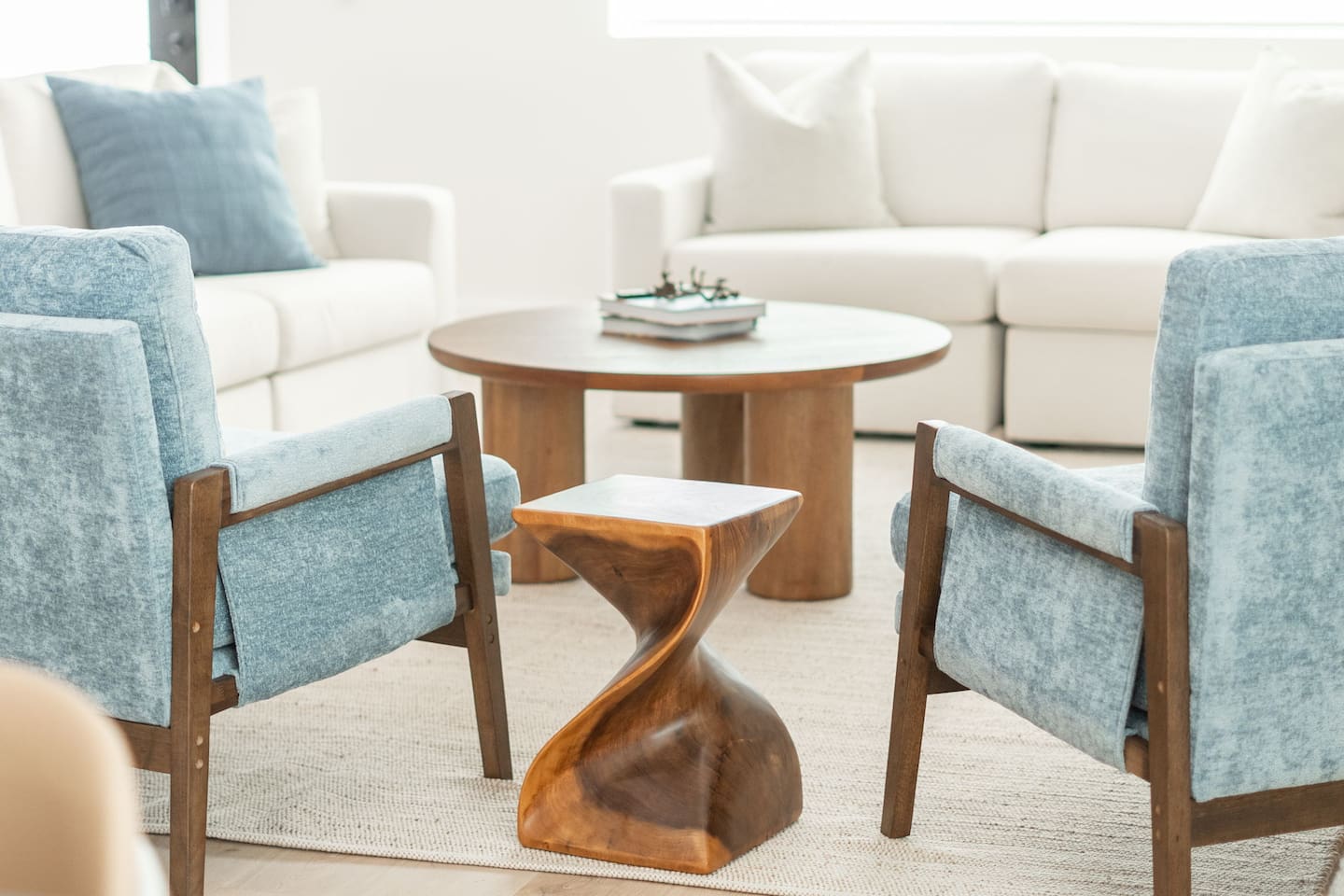 Bright and inviting living room with modern decor, cozy seating, and natural light — the perfect space to relax.