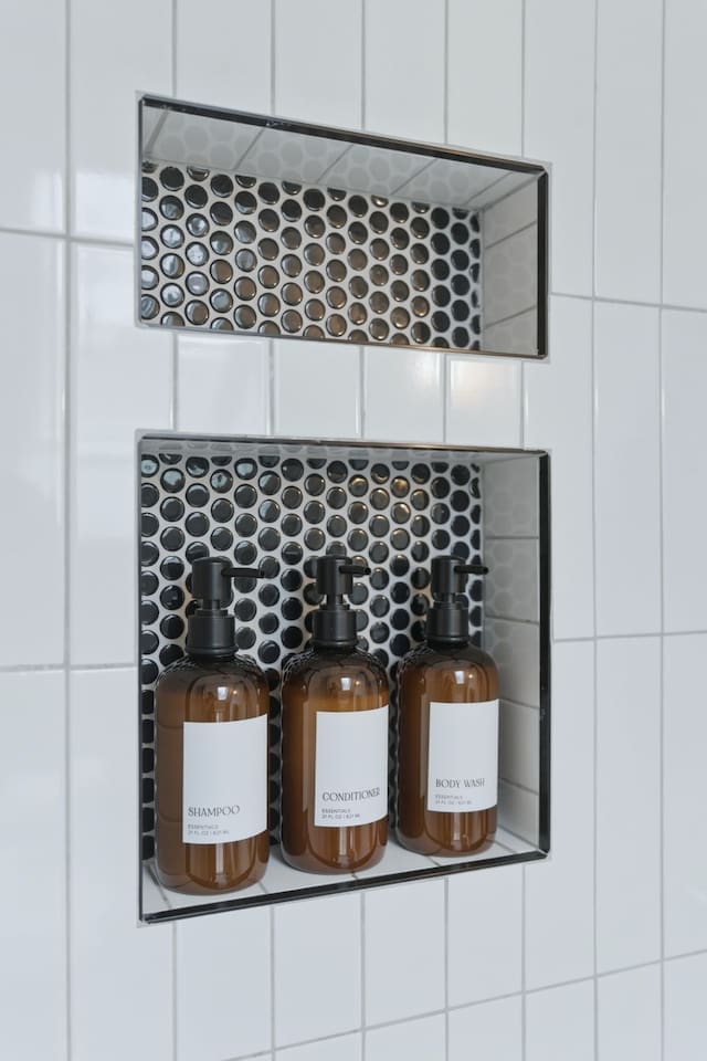 Built-in shower niches stocked with essentials, combining convenience with a sleek, modern design
