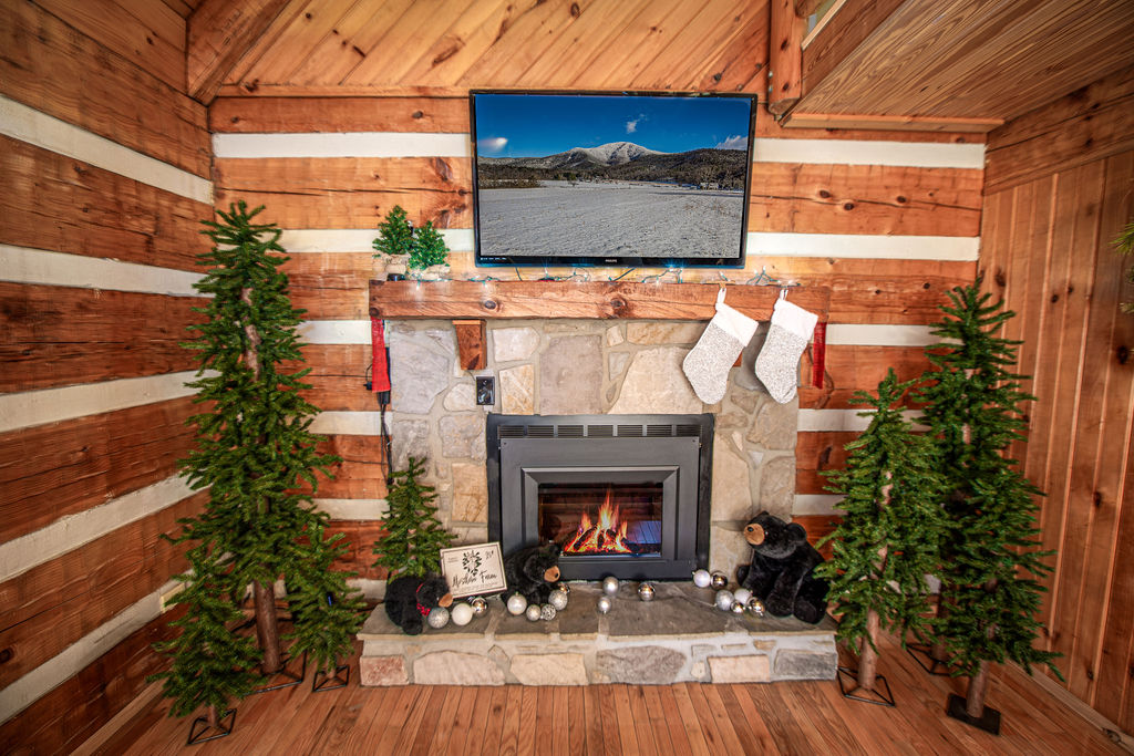 The living room is beautifully decorated for a festive mountain holiday.