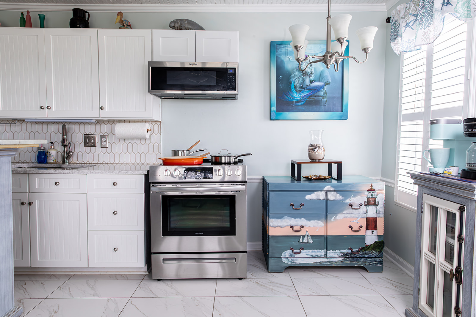 The full kitchen is finished with quartz countertops and includes a stove and oven, microwave, full refrigerator and freezer, and storage for dry goods. Whether you’re cooking dinner or keeping things simple, everything you need is within reach.