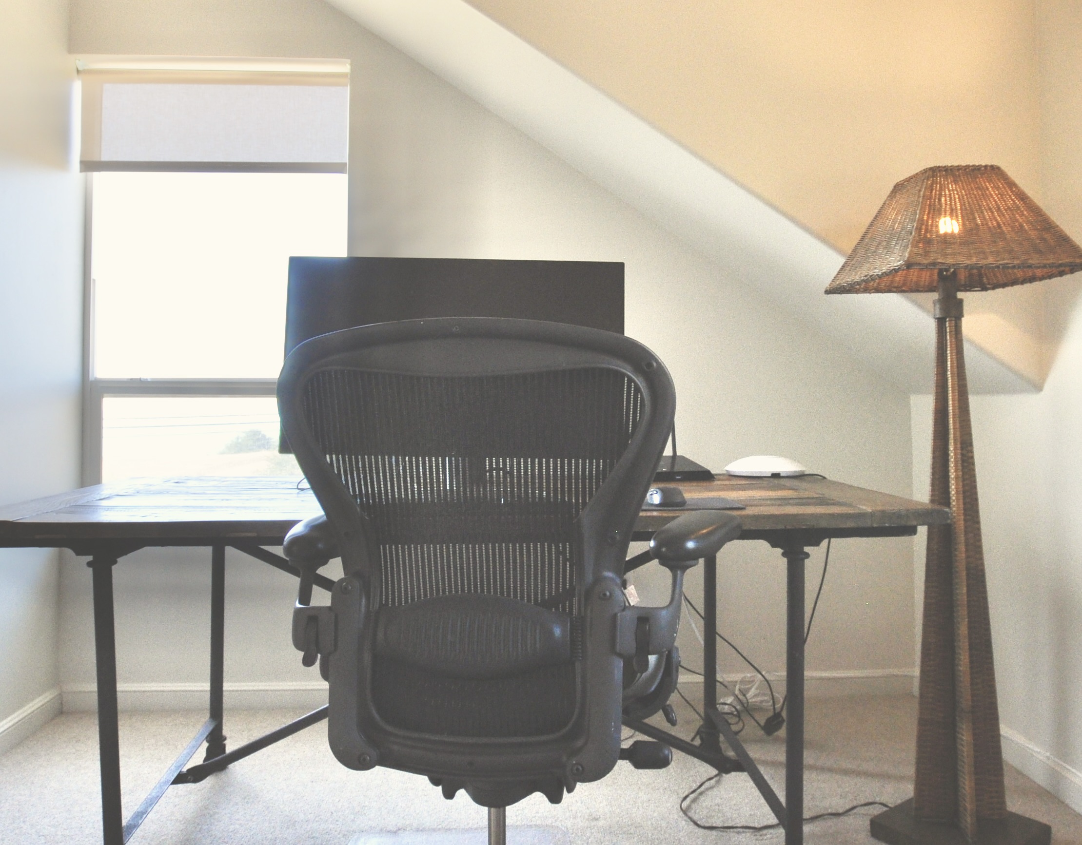 Full desk, office chair and monitor in the office/bedroom, with ocean views
