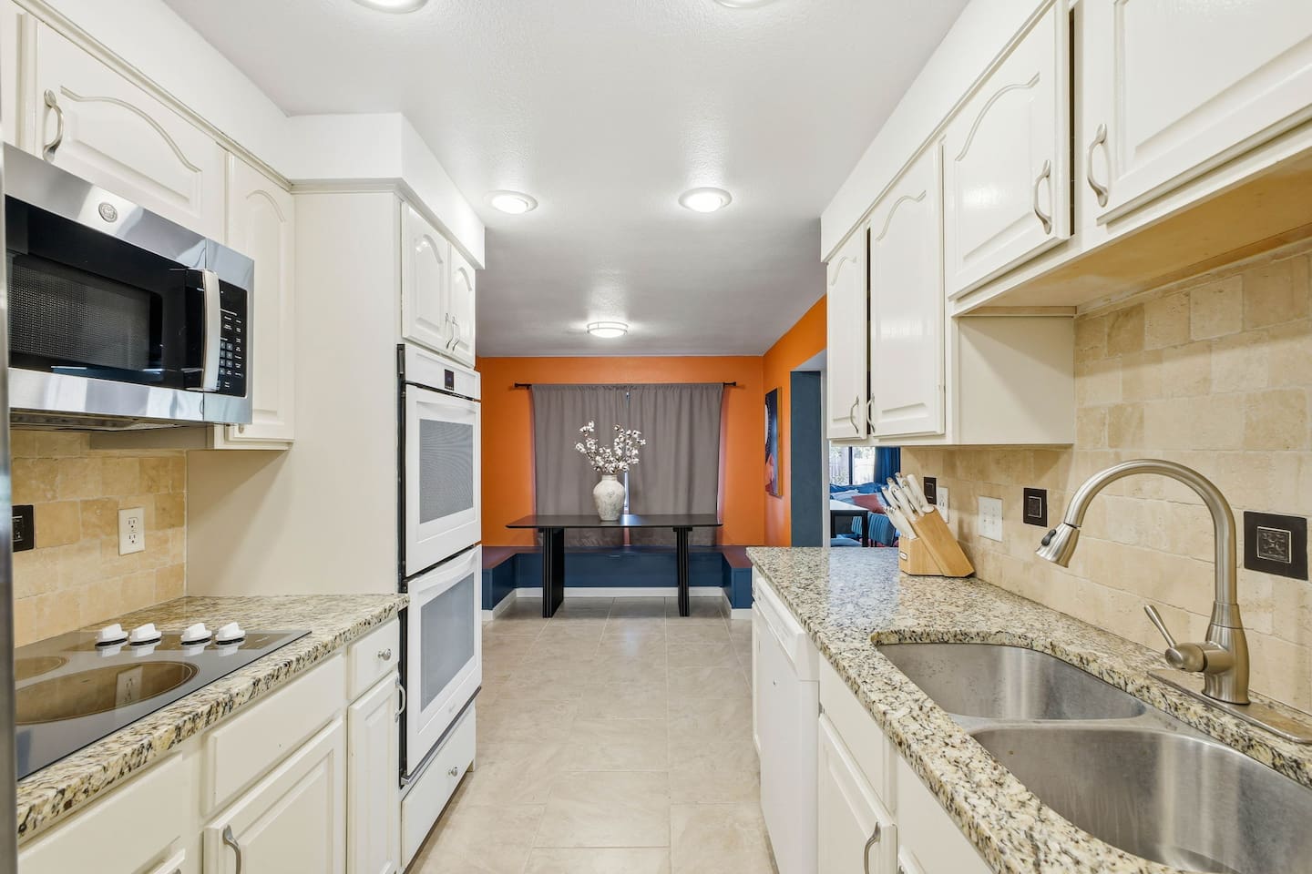 Kitchen with a sitting area in the background