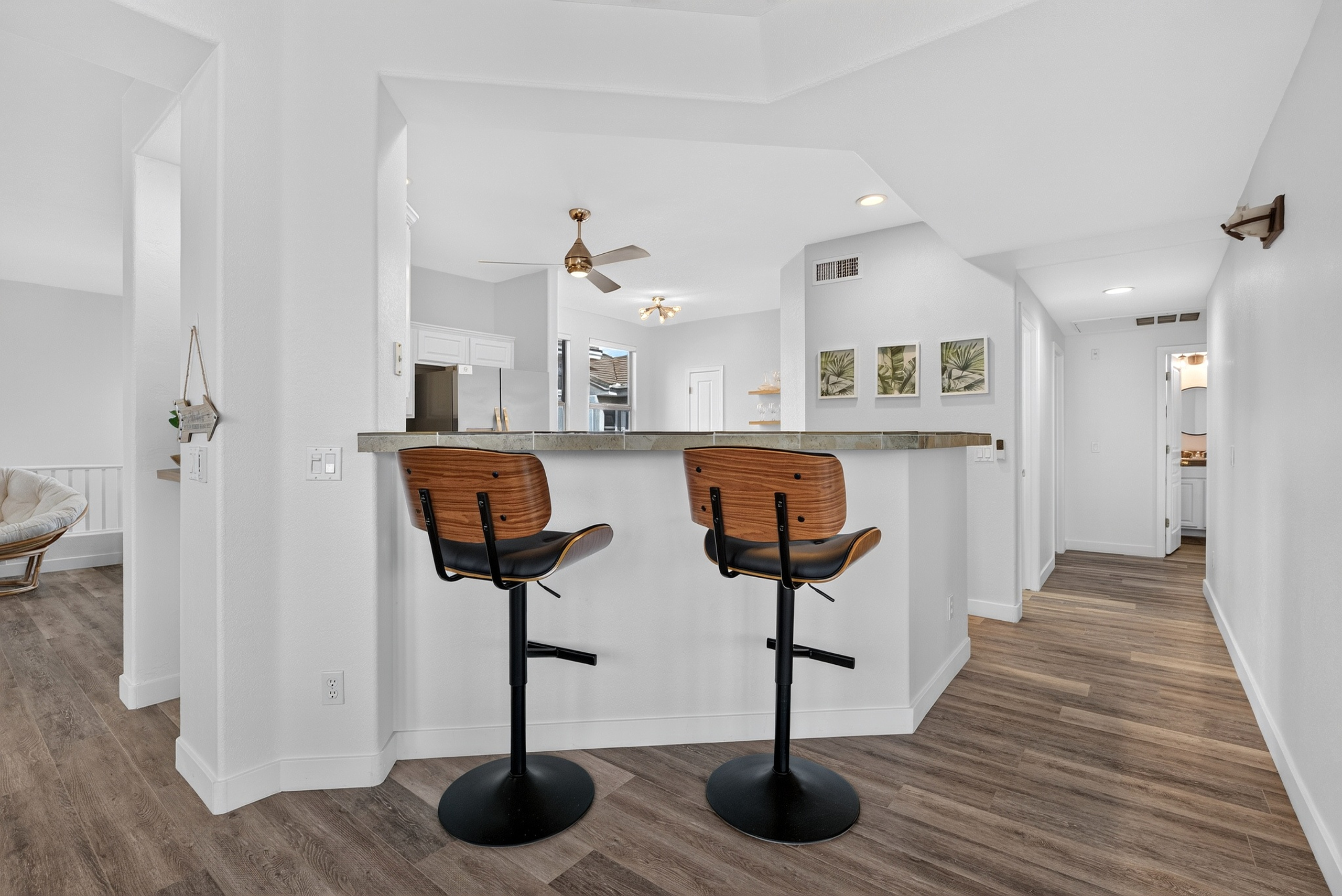 Breakfast bar seating with open kitchen views, natural light, and easy access to the main living spaces.