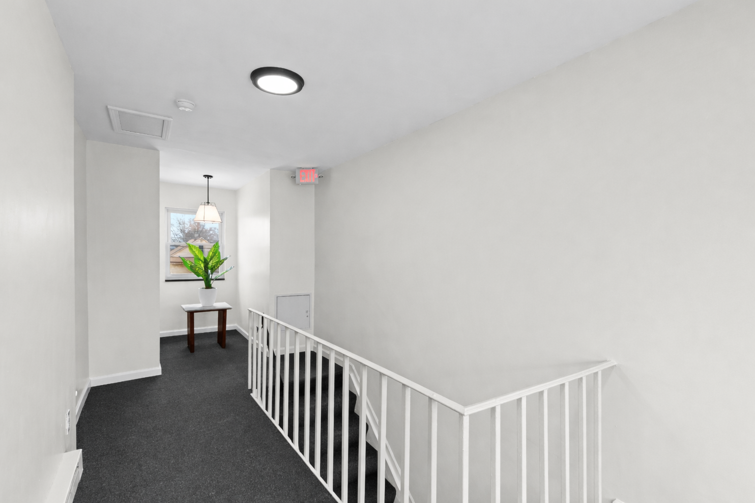 Clean, quiet interior hallway with soft lighting and modern finishes—easy access to the unit and a calm, well-kept common area.