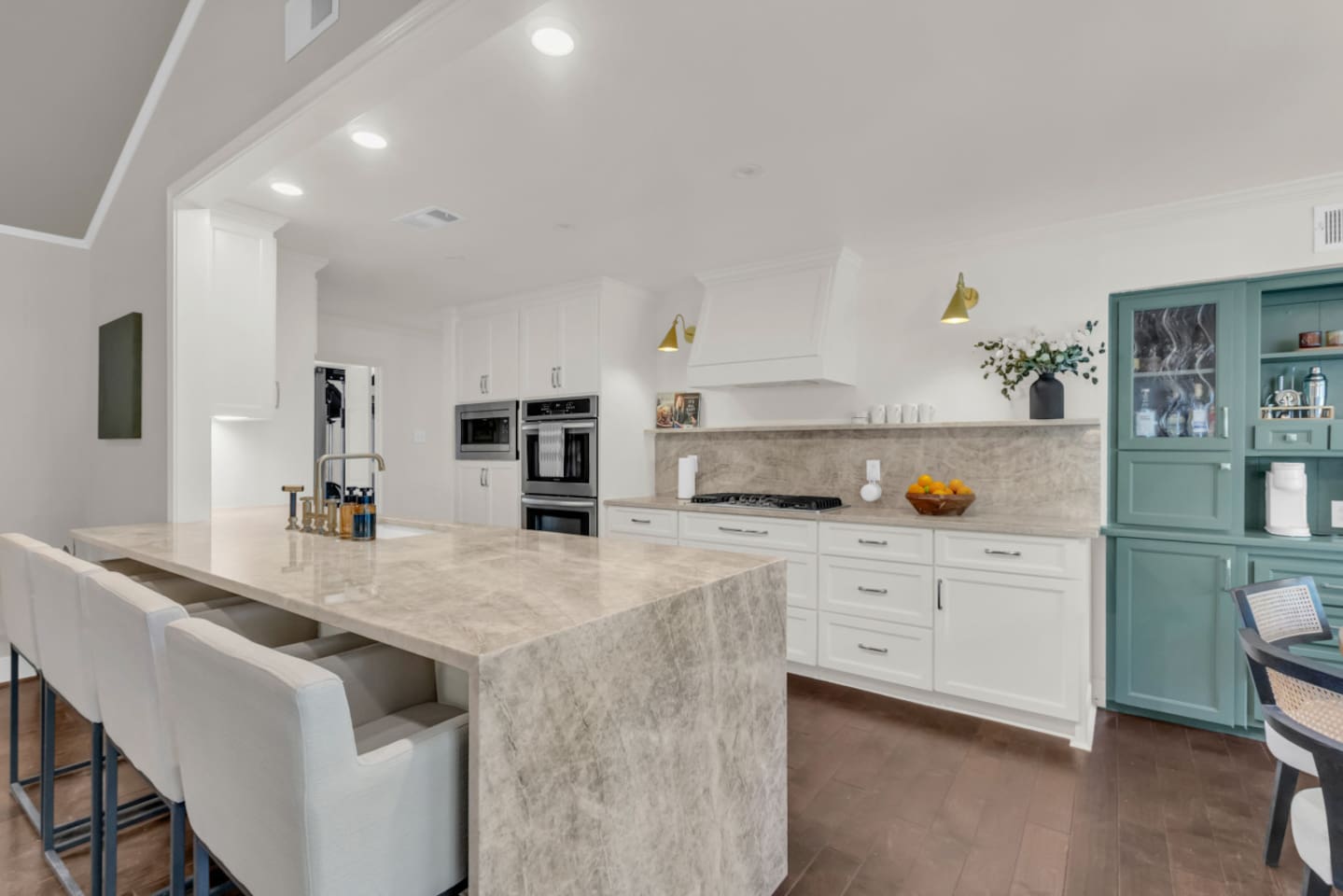 Luxe kitchen with a high-end feel, fully stocked with all essentials, featuring an oversized island with bar seating for casual dining and gathering.