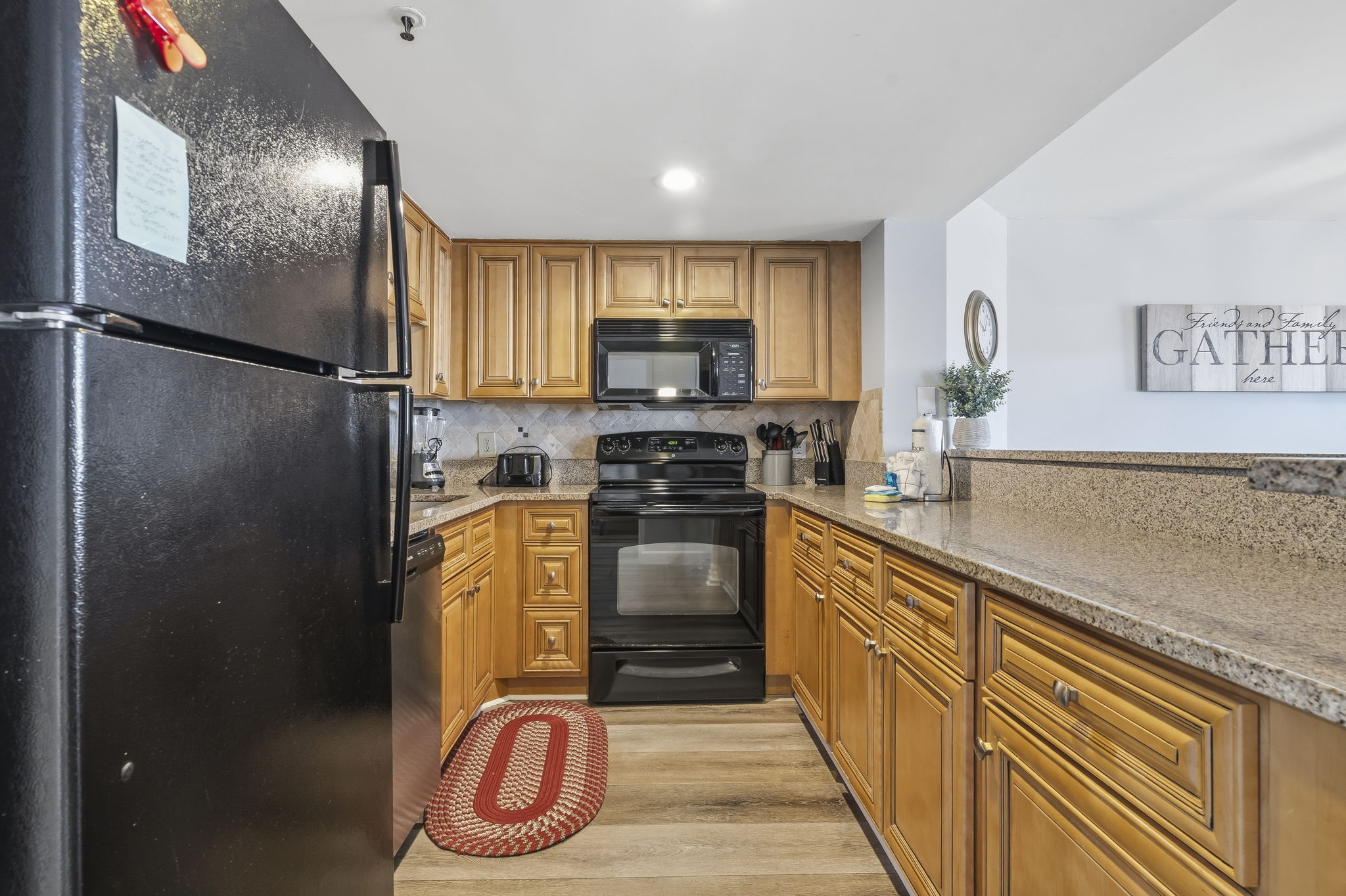Kitchen with refrigerator, electric range and built-in microwave