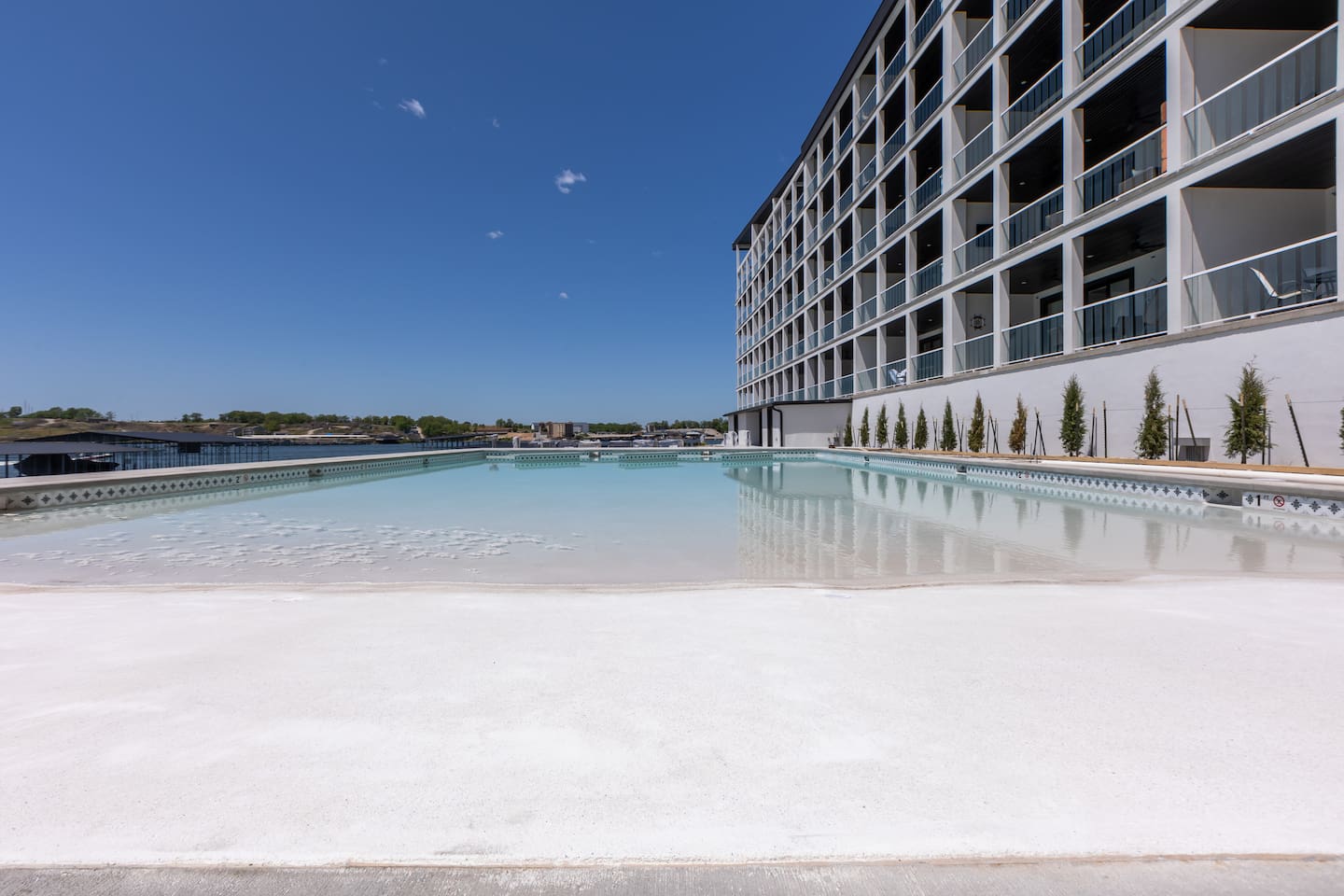 Resort Pool 1 has a beach entry, table in the water, and fountains.
