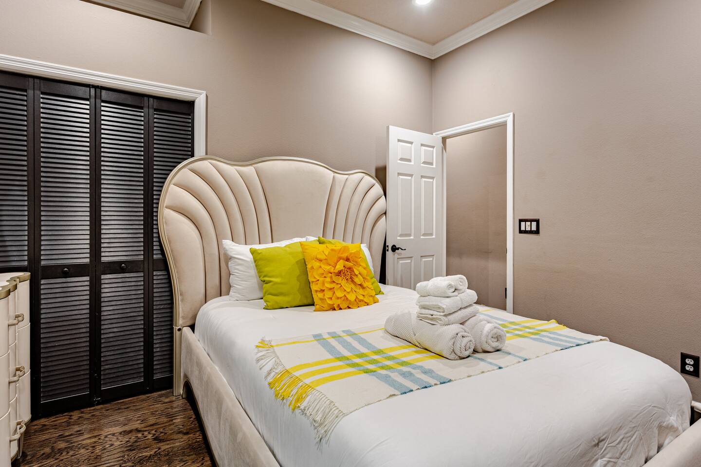 Beautifully appointed guest room featuring elegant furnishings, a plush bed, and a warm, inviting ambiance designed for comfort, relaxation, and a restful stay.
