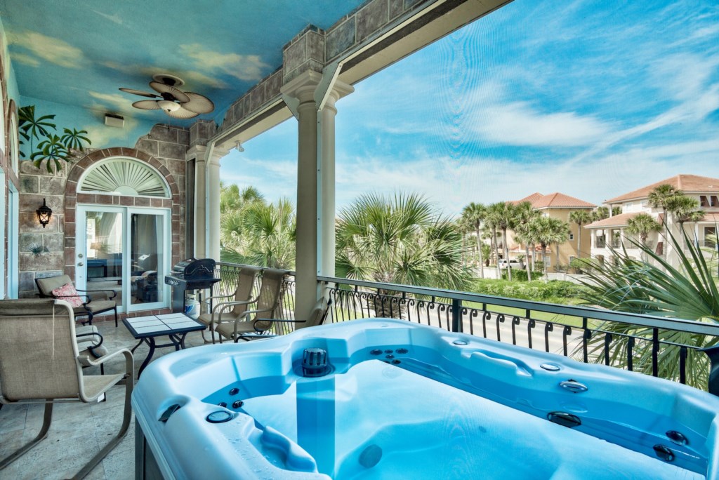 Private balcony featuring a BBQ grill, lounge area, and hot tub (propane included)