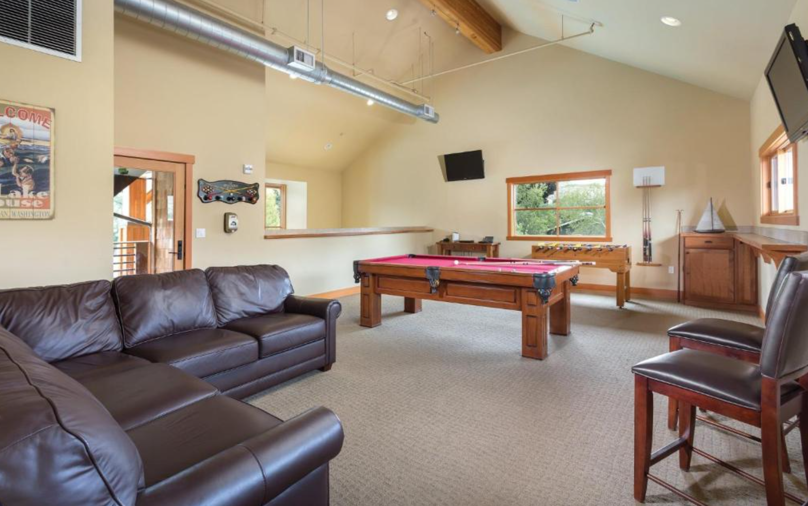 Communal / shared game room with pool table foosball, darts, card table, plus DVD and board games rentals