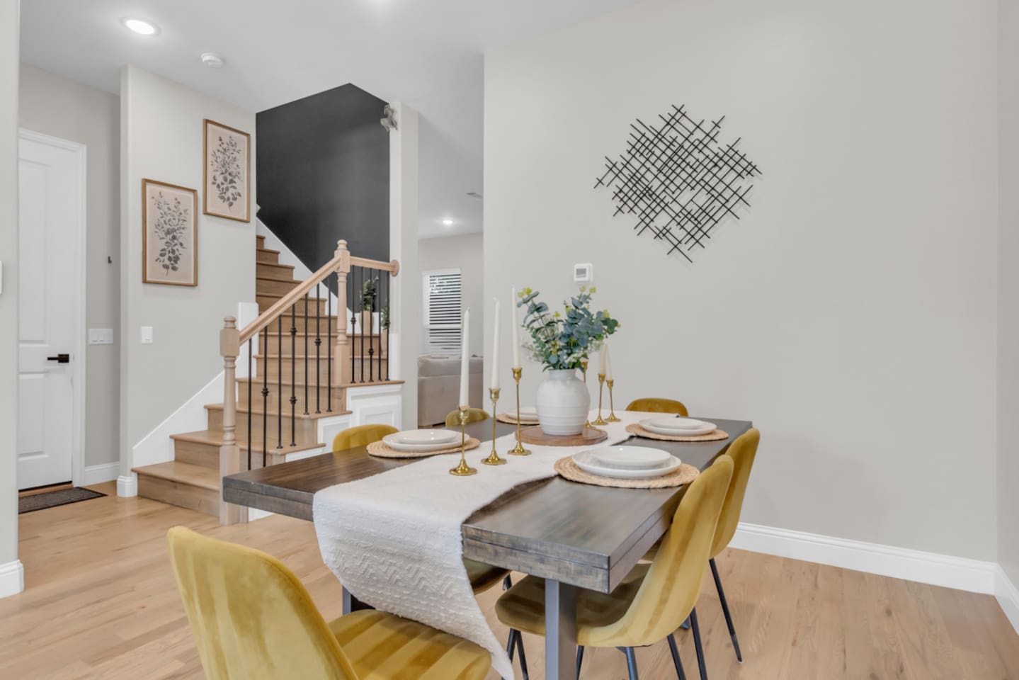 Elegant dining area with seating for six and wall accents.