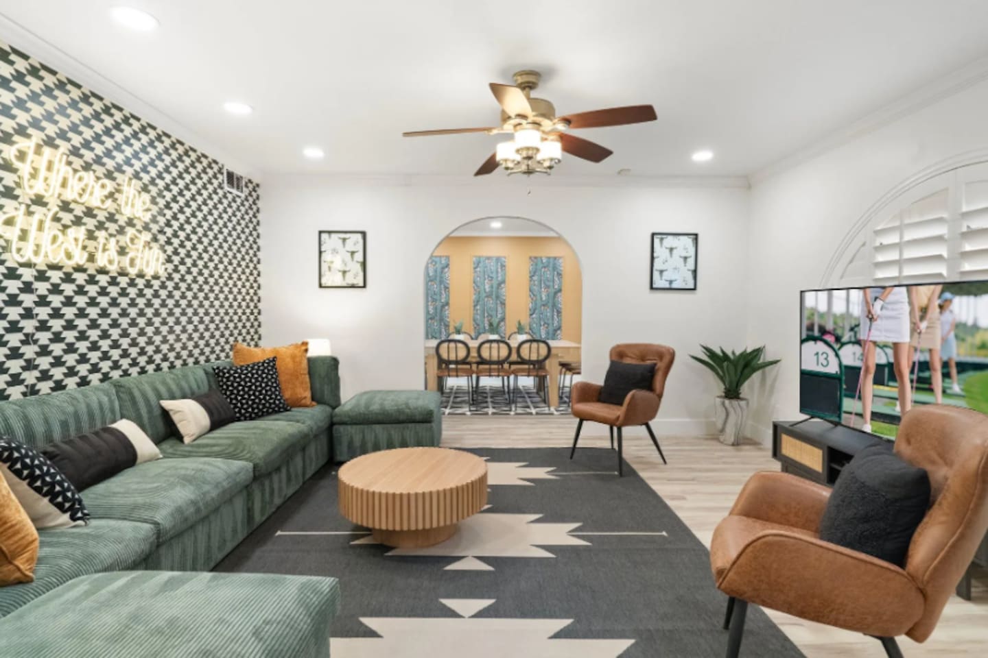 The living room flows straight into a sun-drenched dining nook, so the group never really splits up between lounging and dinner. Curl into the oversized sectional, soak up the neon glow, and let the night stretch on a little longer.
