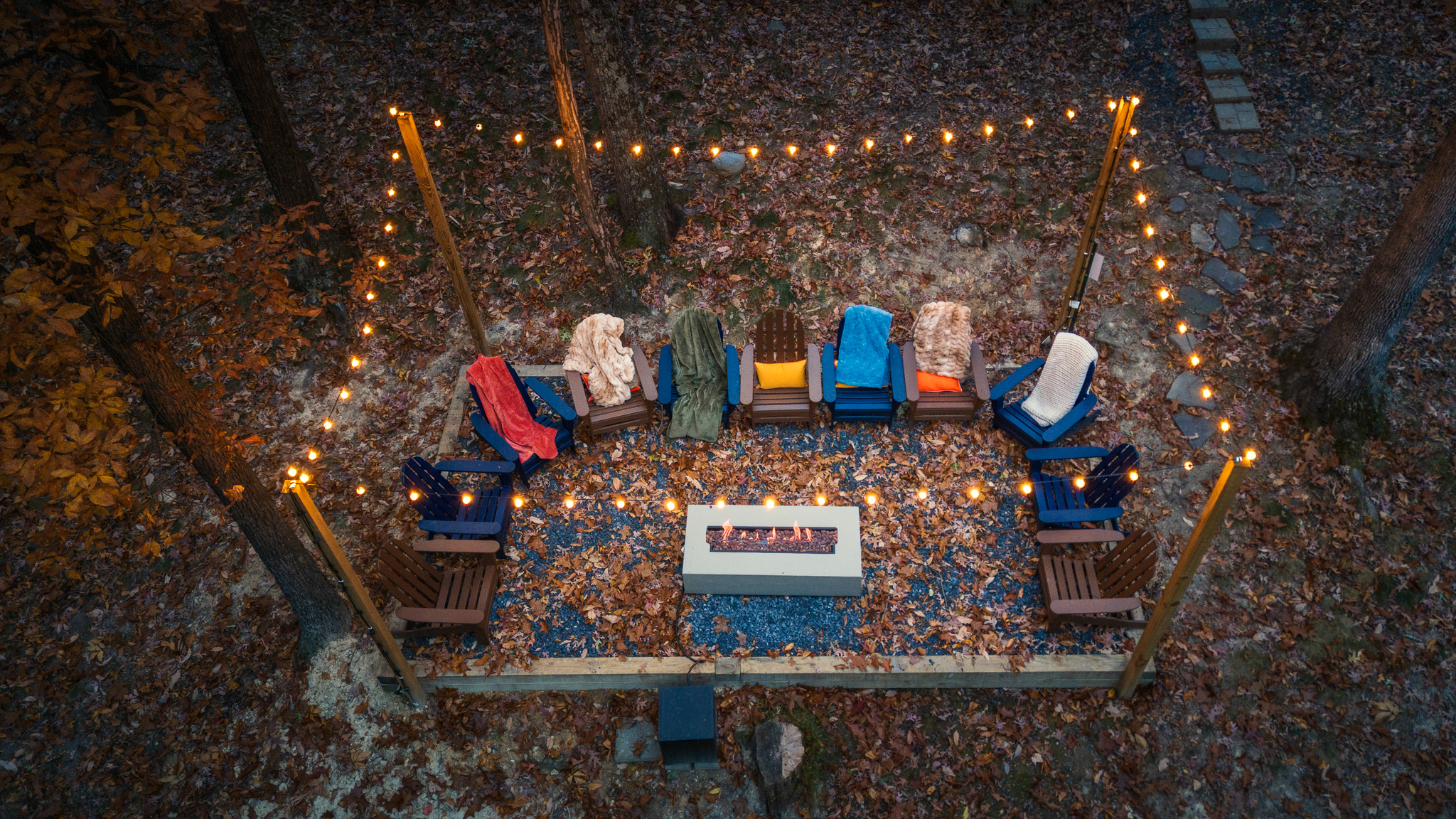 Gather ‘round the fire pit under string lights for s’mores, stories, and stargazing