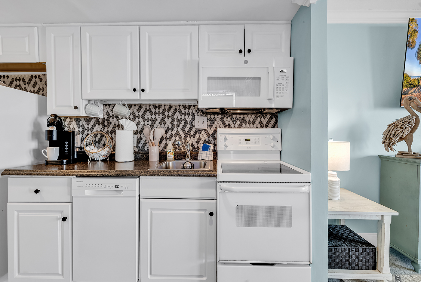 Kitchen with microwave, stovetop, and counter appliances — everything you need to cook at home