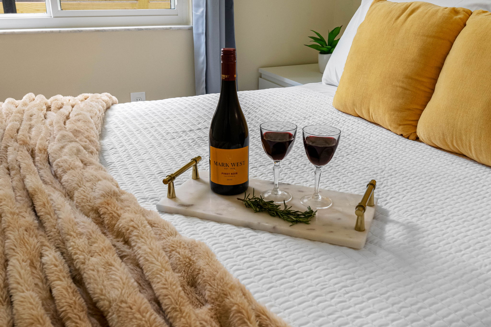 Dressed in crisp white linens and accented with soft textures and warm hues.