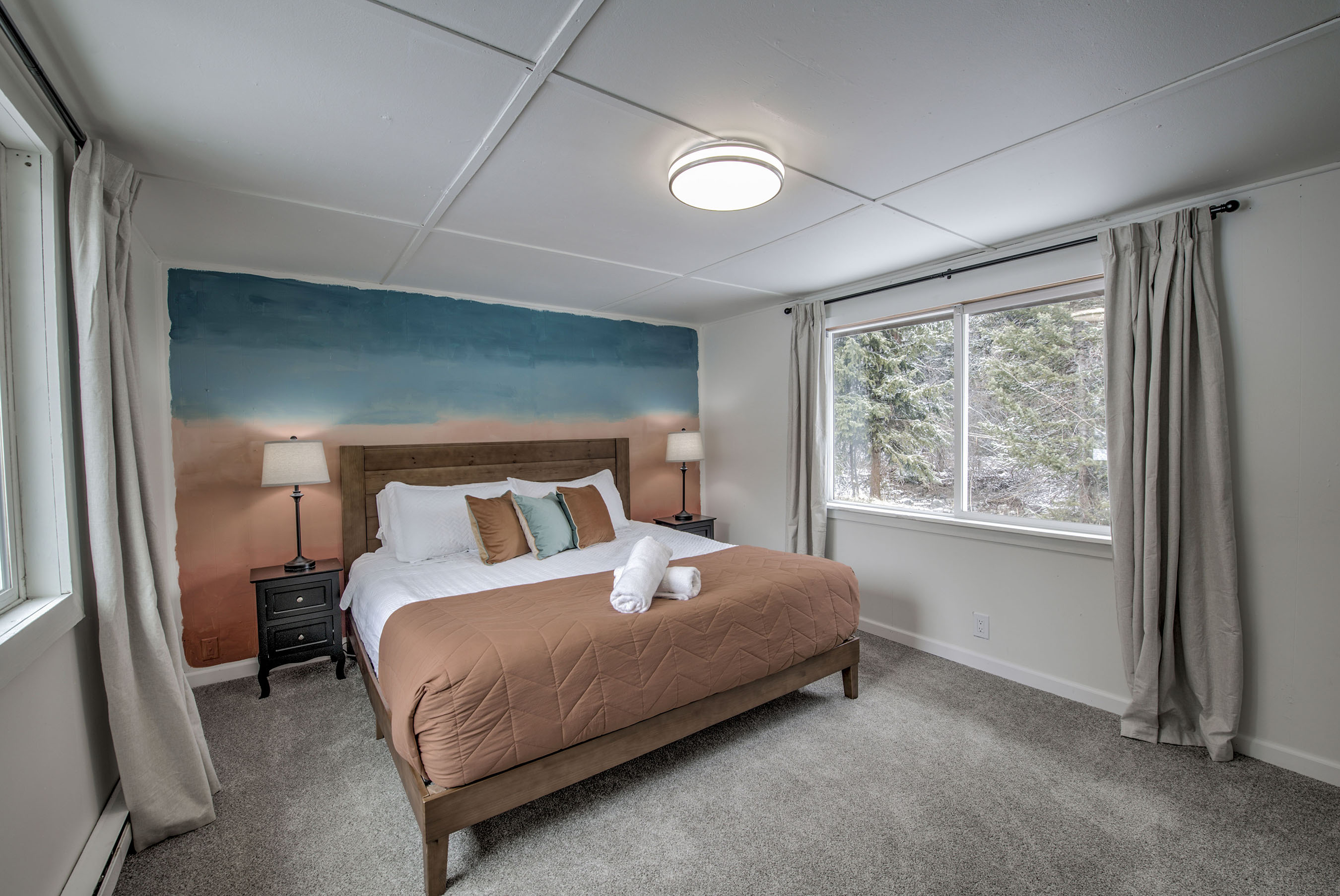 Recharge in your serene bedroom—plush bedding, soft light, and peaceful views create a calming retreat that’s all yours. Just outside the window, you will hear Spruce Creek running from April to November; the incredibly beautiful sounds lull you to sleep. 