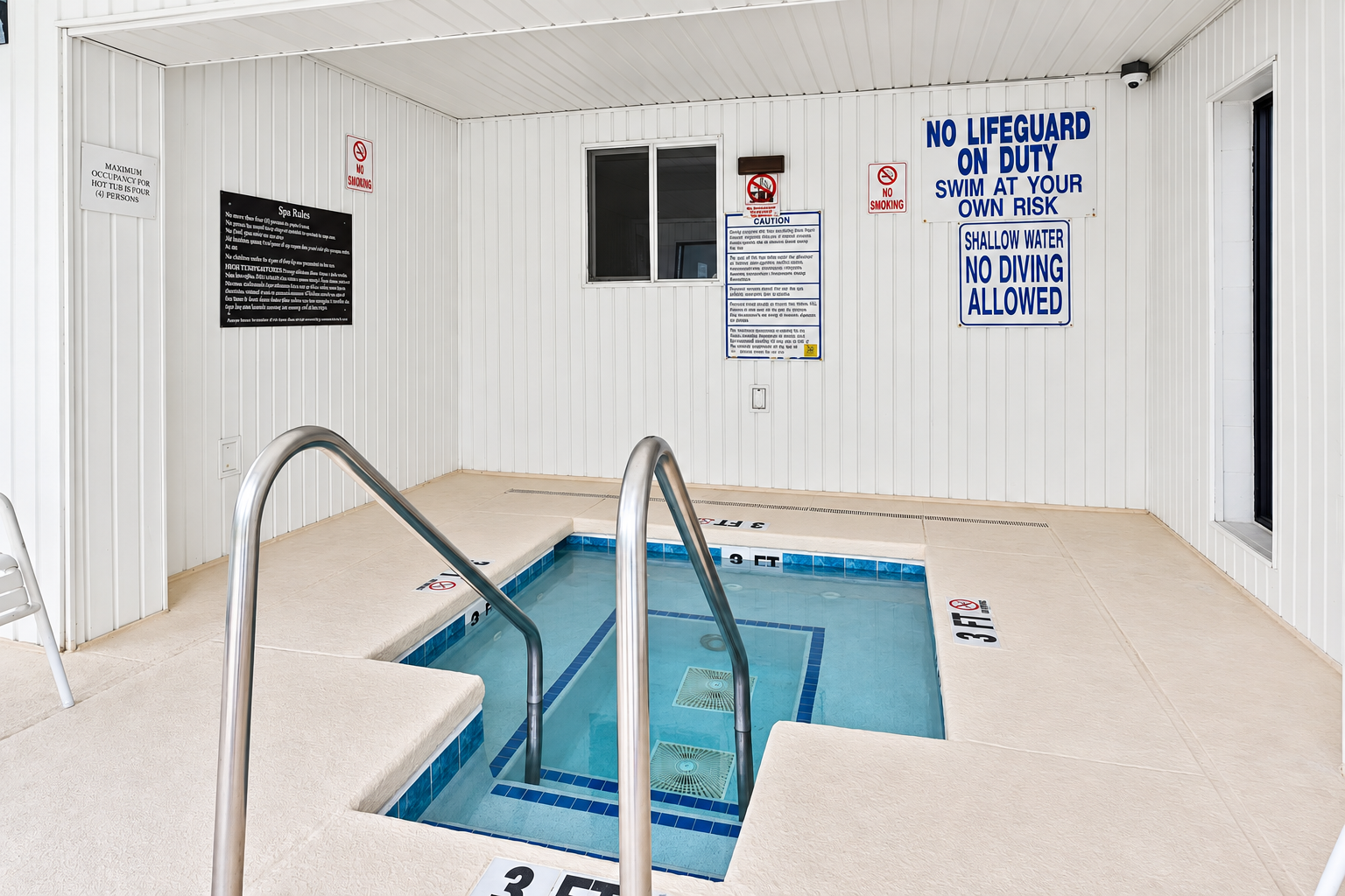 Shared indoor hot tub at Holiday Towers with posted safety rules and pool area access nearby.