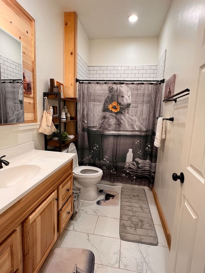 There are five bathrooms at Mama Bear Cabin.  This bathroom, with a tub and shower, is on the main floor next to The Great Room with easy access to the hottub.