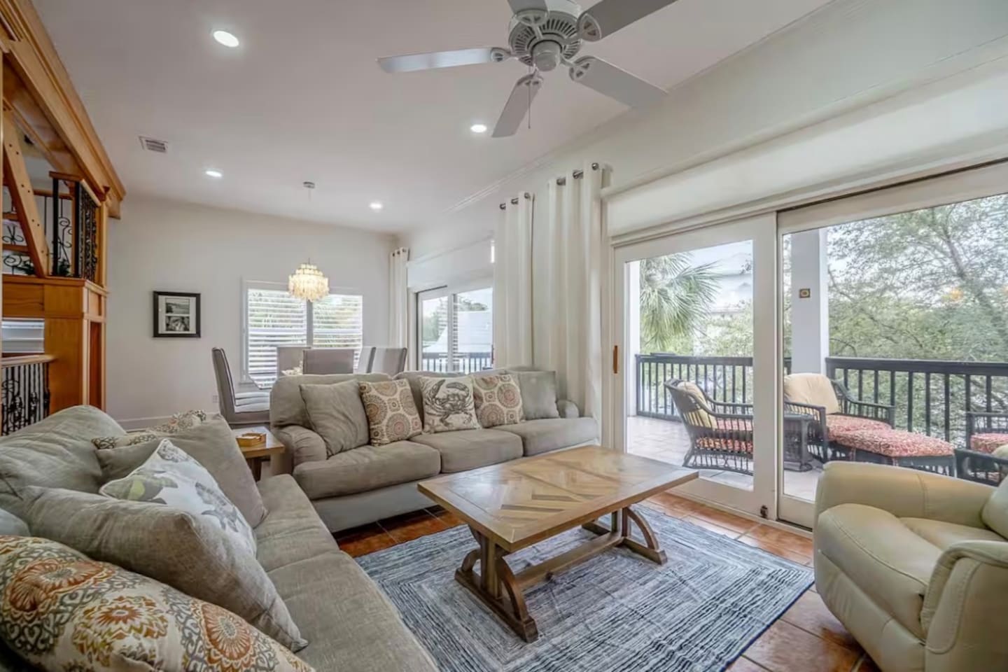 Open floor plan with living and dining space connected to outdoor balcony with additional seating for gathering