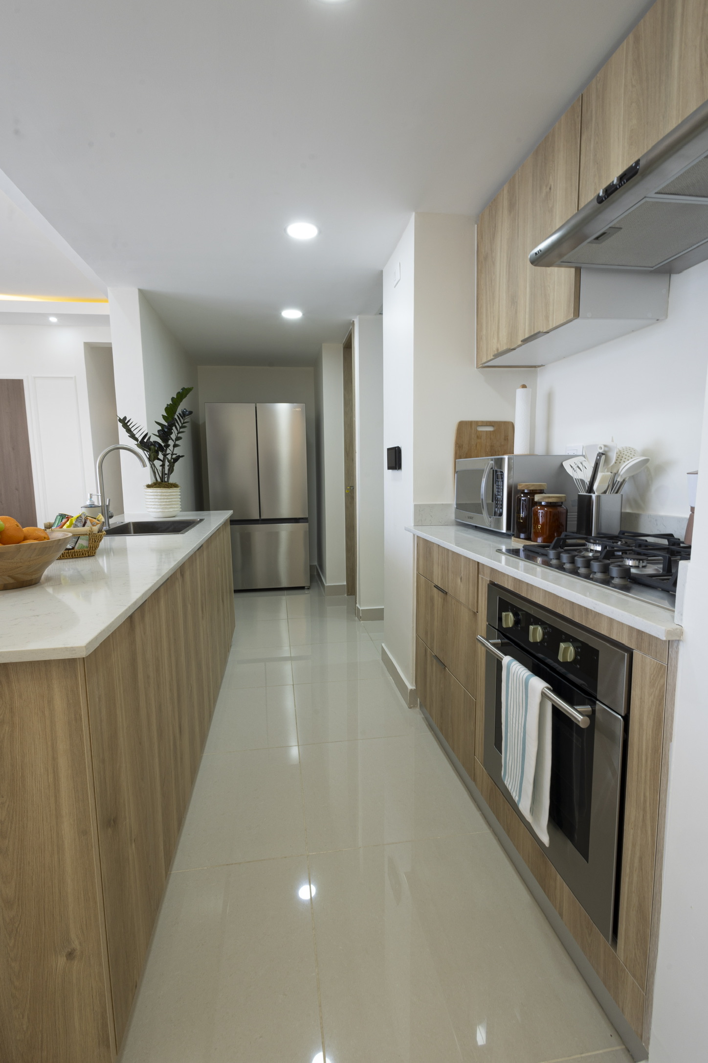 Fully equipped kitchen with full-size refrigerator, gas cooktop, oven, microwave, cookware, and plenty of counter space for meals at home. 🍳☕✨