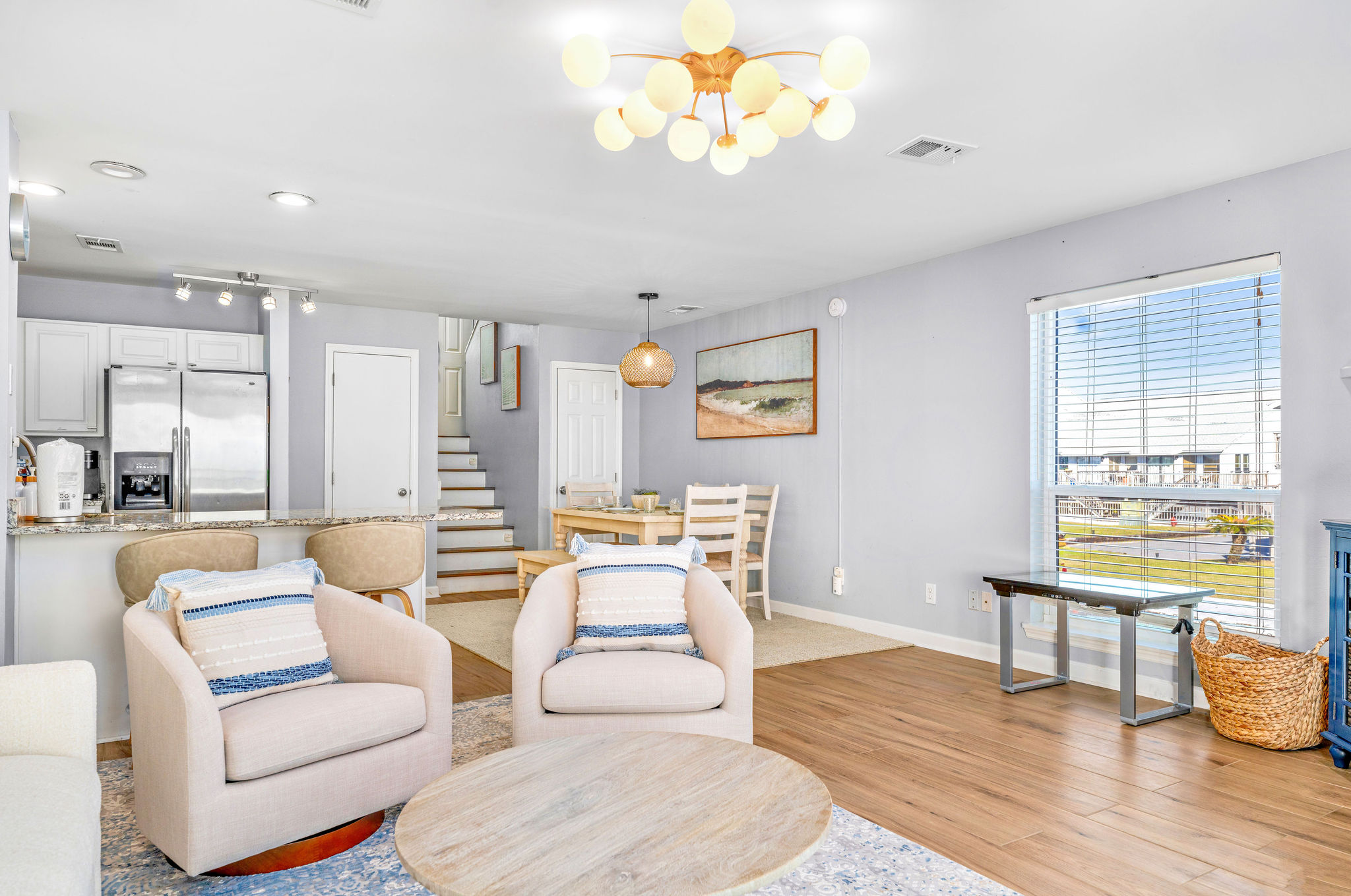 The living room is designed for both relaxation and entertainment, featuring an Infinity Game Table by the window. This interactive table offers a wide variety of digital games, providing fun and engaging activities for both kids and adults. 