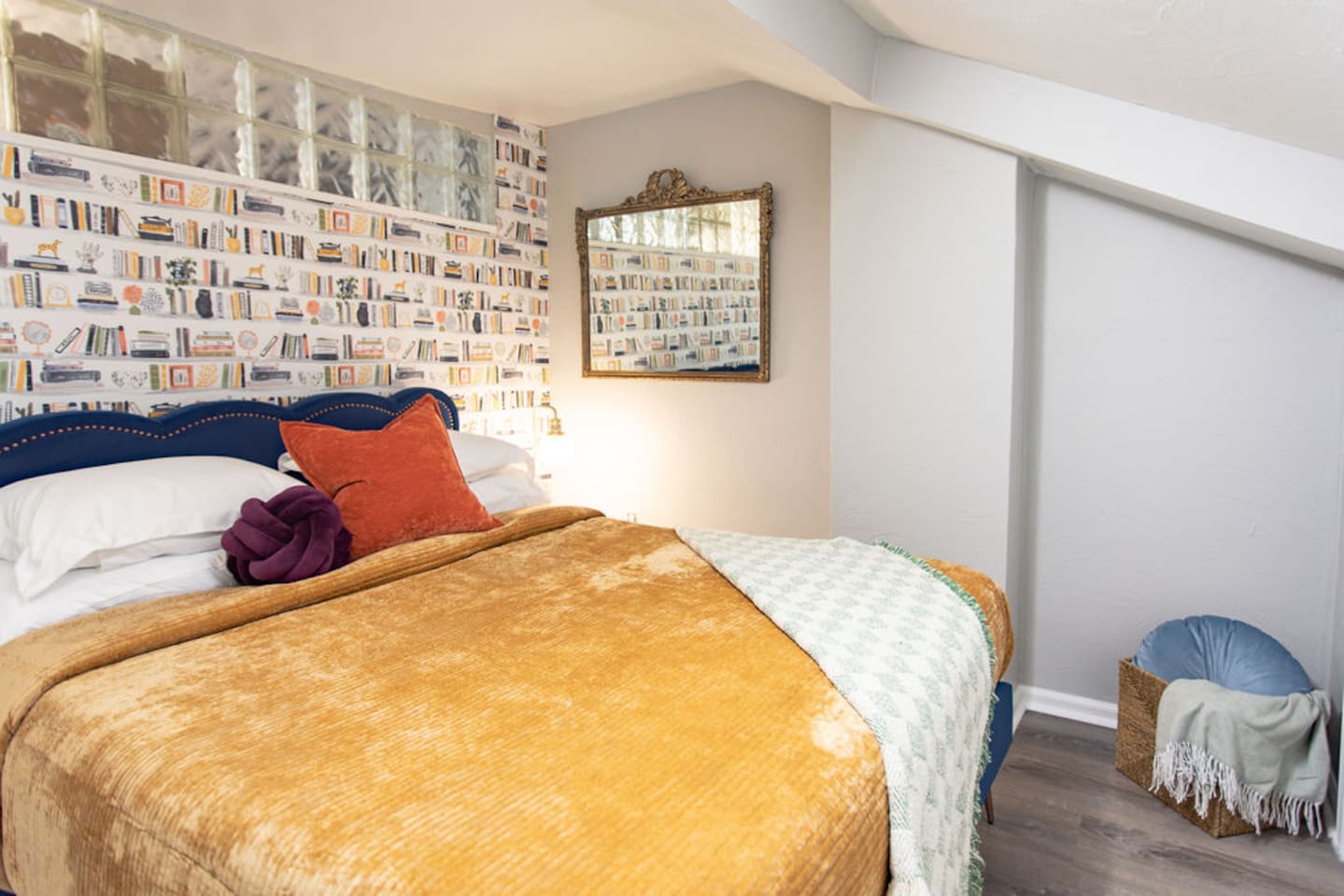 Cozy queen bedroom with bright accents, creating a cheerful and inviting atmosphere.