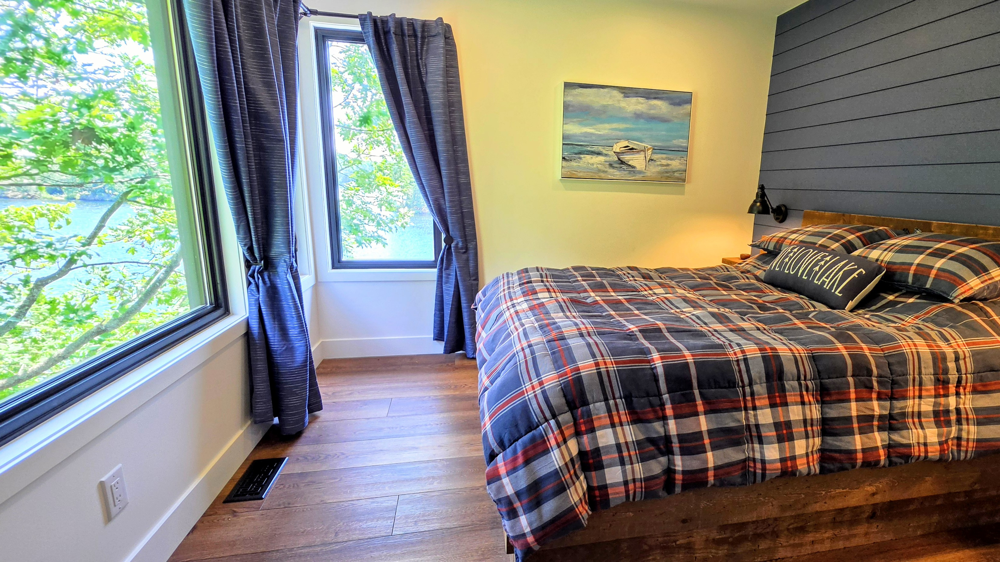 Main floor 2nd bedroom with corner window view of Lac McGregor