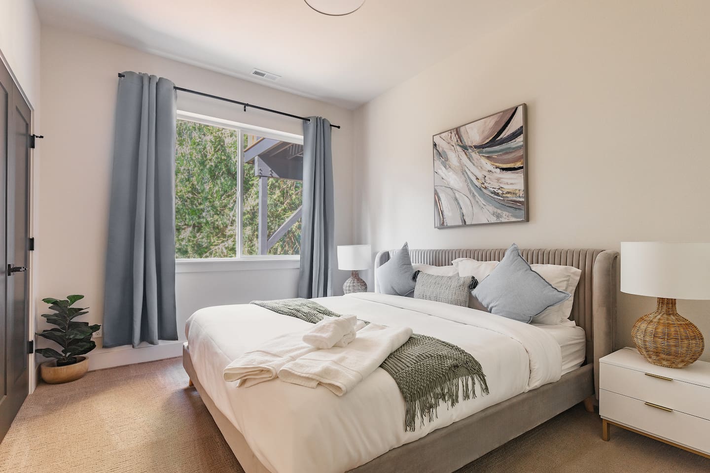 This is one of the three bedrooms downstairs, featuring a medium king mattress bed.