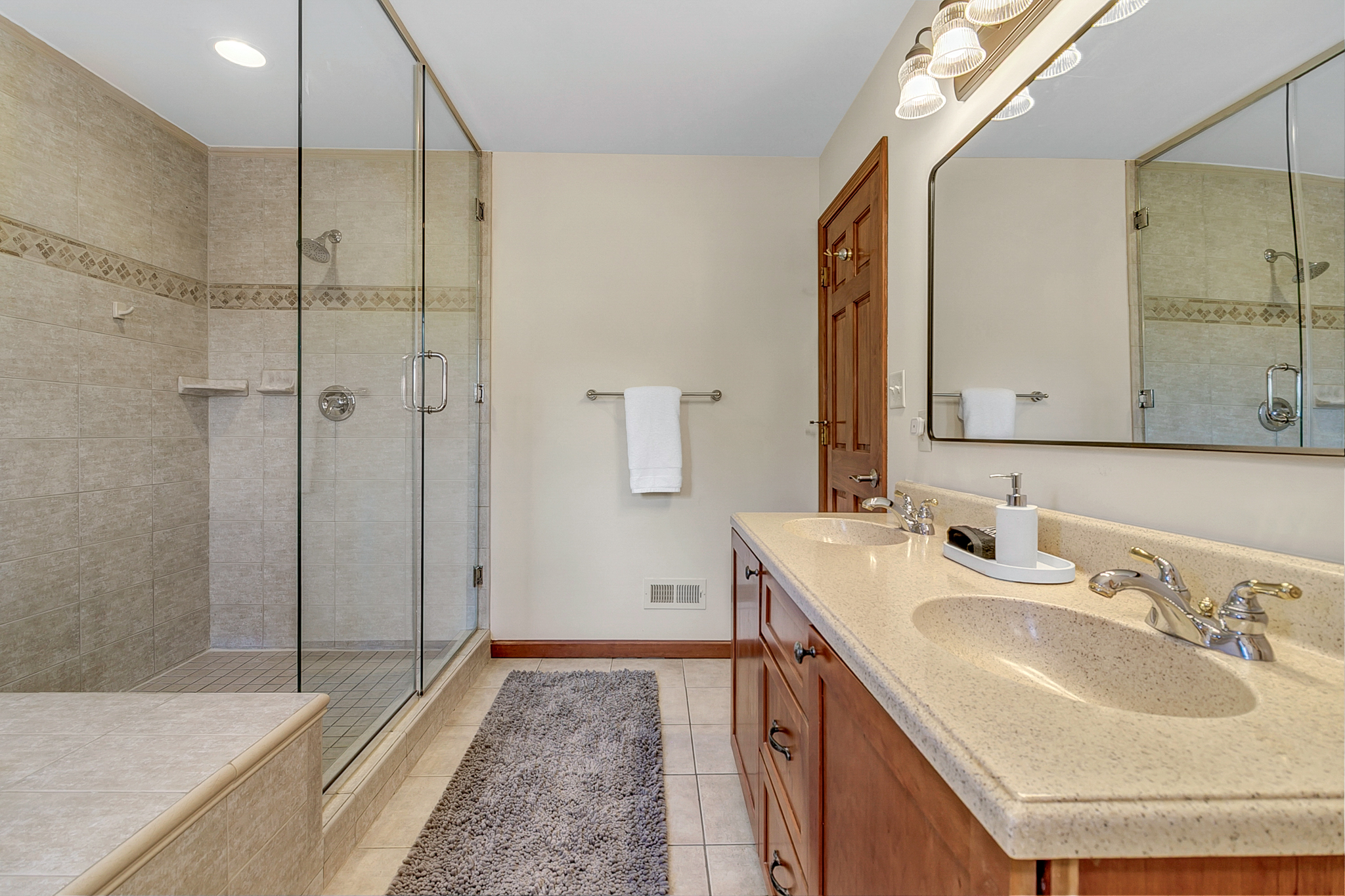 Upstairs Primary Bathroom Suite with jetted tub, walk-in shower, double vanity, and toilet with bidet. 