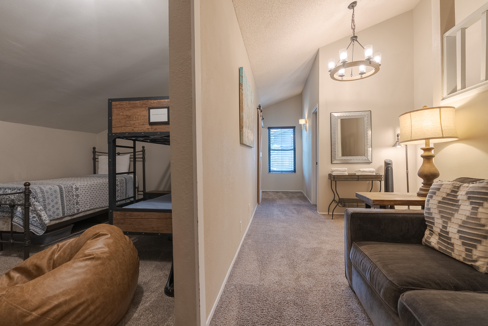 The kid's loft is at one end, and the queen bedroom is at the far end near the window.   Allowing for a bit of separation.