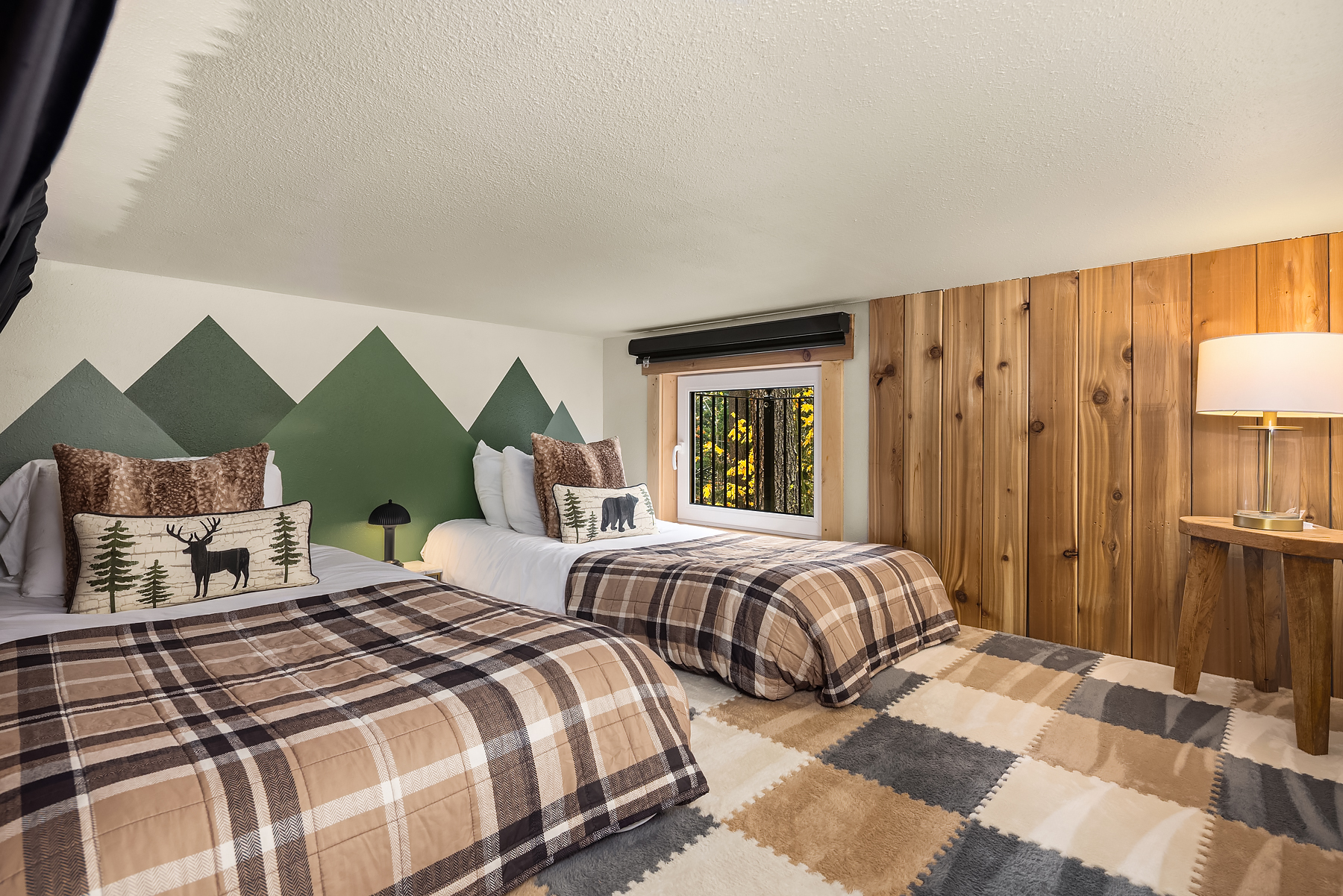 Bedroom #3: Downstairs mini, open sleeping loft; well suited for kiddos, ceiling height is approx. 4 ft