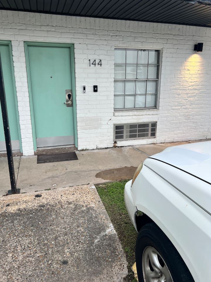 Parking area near the unit with open spaces and a short walk to the front door.
