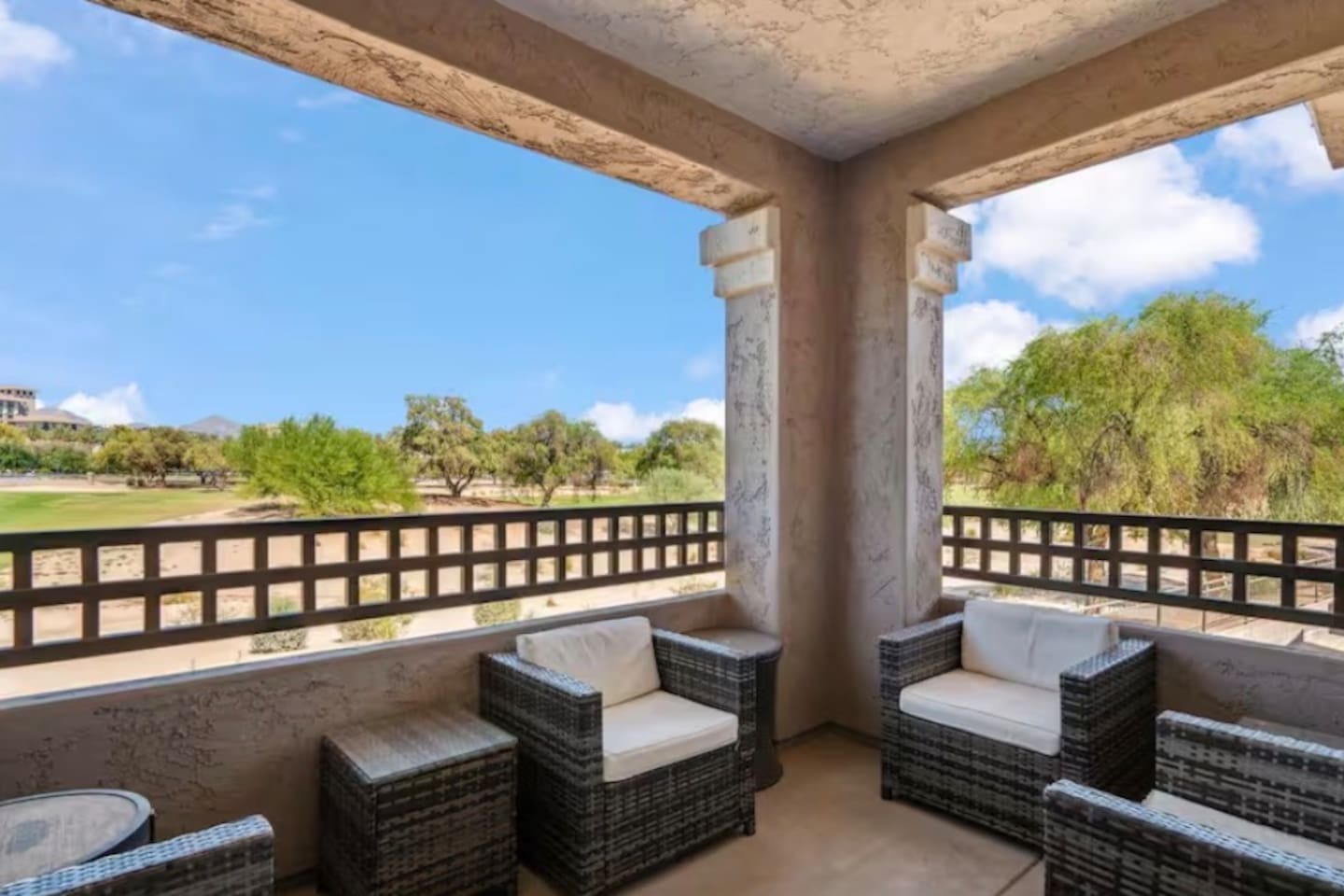 Covered balcony with outdoor seating and open desert views for coffee, reading, or fresh-air downtime.