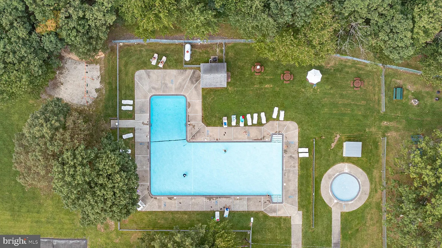 Aerial pool view — community perks in full color.