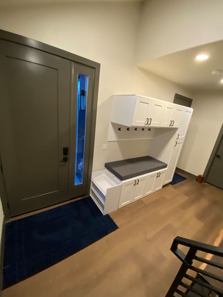 Entryway with mud room and changing area.