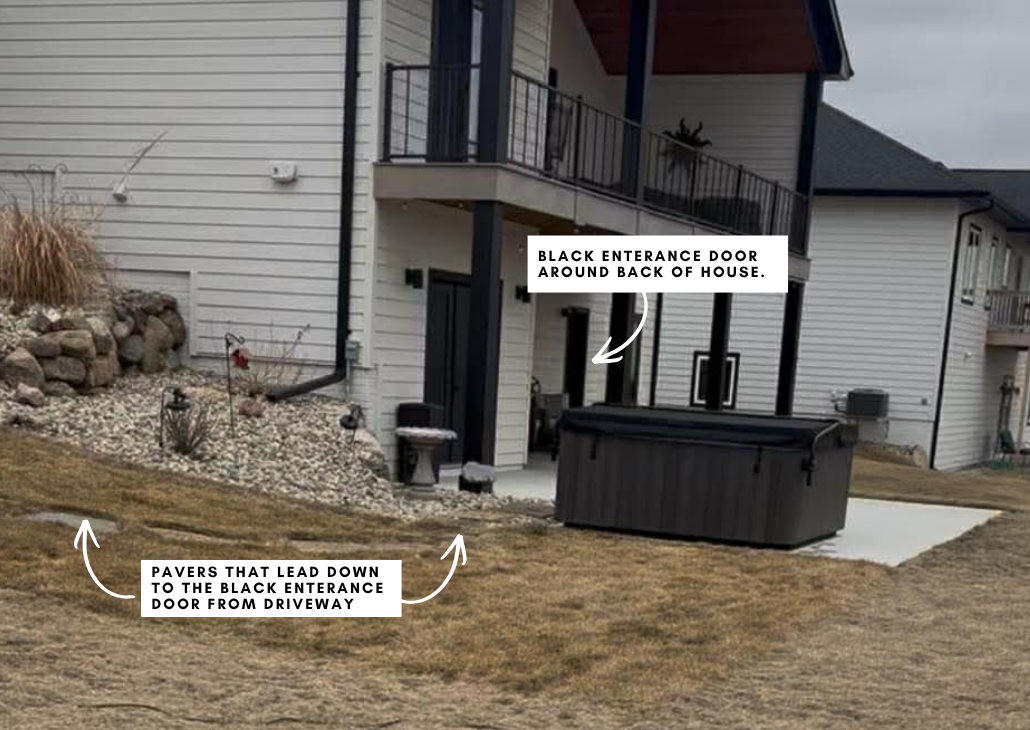 There are pavers (not a sidewalk) that leads from the driveway down to the patio area by the black entrance door. 