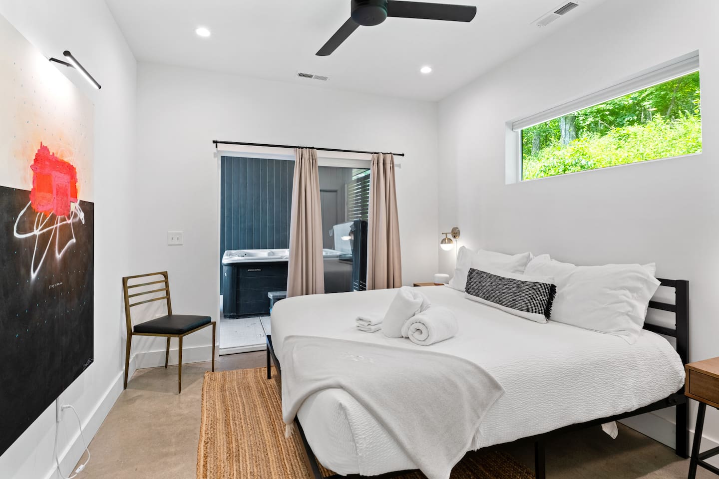 Primary bedroom with attached ensuite. Sliding glass doors make for easy access to the hot tub and breezeway. 